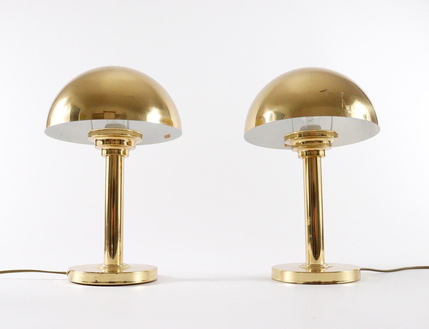 Brass Art Deco style table lamps. Made in Austria in the manner of Josef Hoffmann, in the 1970s. The lamps are made in polished brass that has become a very nice patination. Mushroom -shaped shades covers the socket element and creates a pleasant