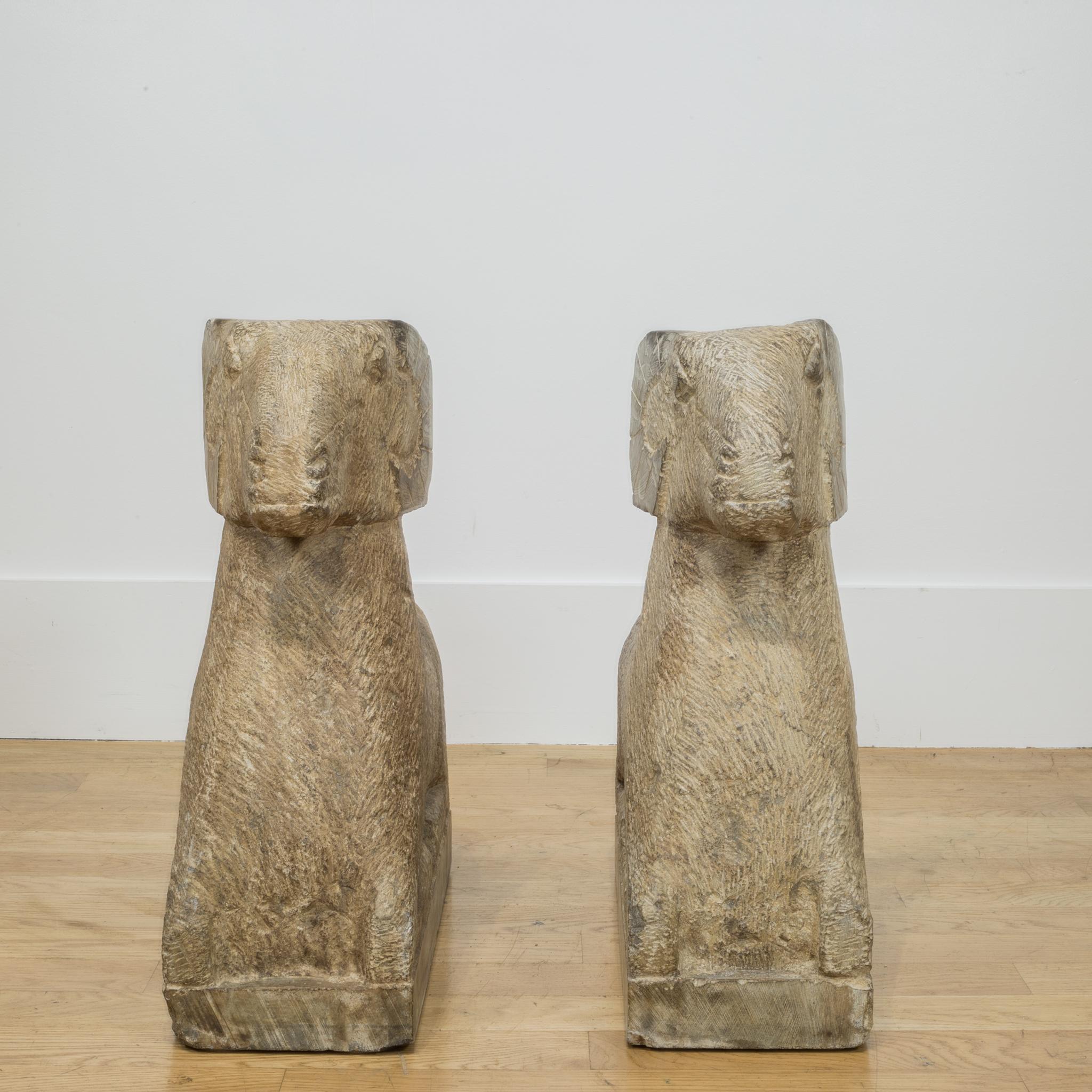 About:

A striking pair of art deco style rams in a reclining position. Carved from blocks of solid sandstone, each ram is intricately carved to show texture in the horns, eyes and the coat. The sculptures can be used in an indoor setting or as