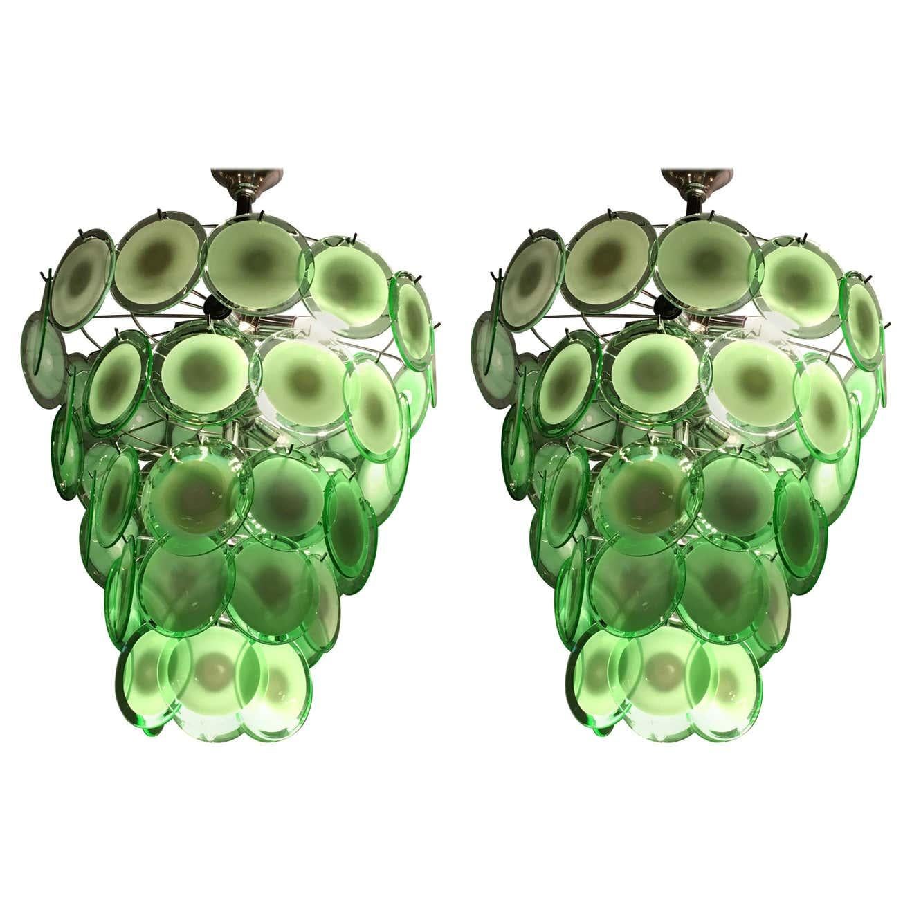 A pair of art deco style circular Murano glass sphere chandeliers. Each having fifty circular Murano glass spheres approximately six inches in diameter. This pair having mint green and white glass disks. We have recently acquired a warehouse which