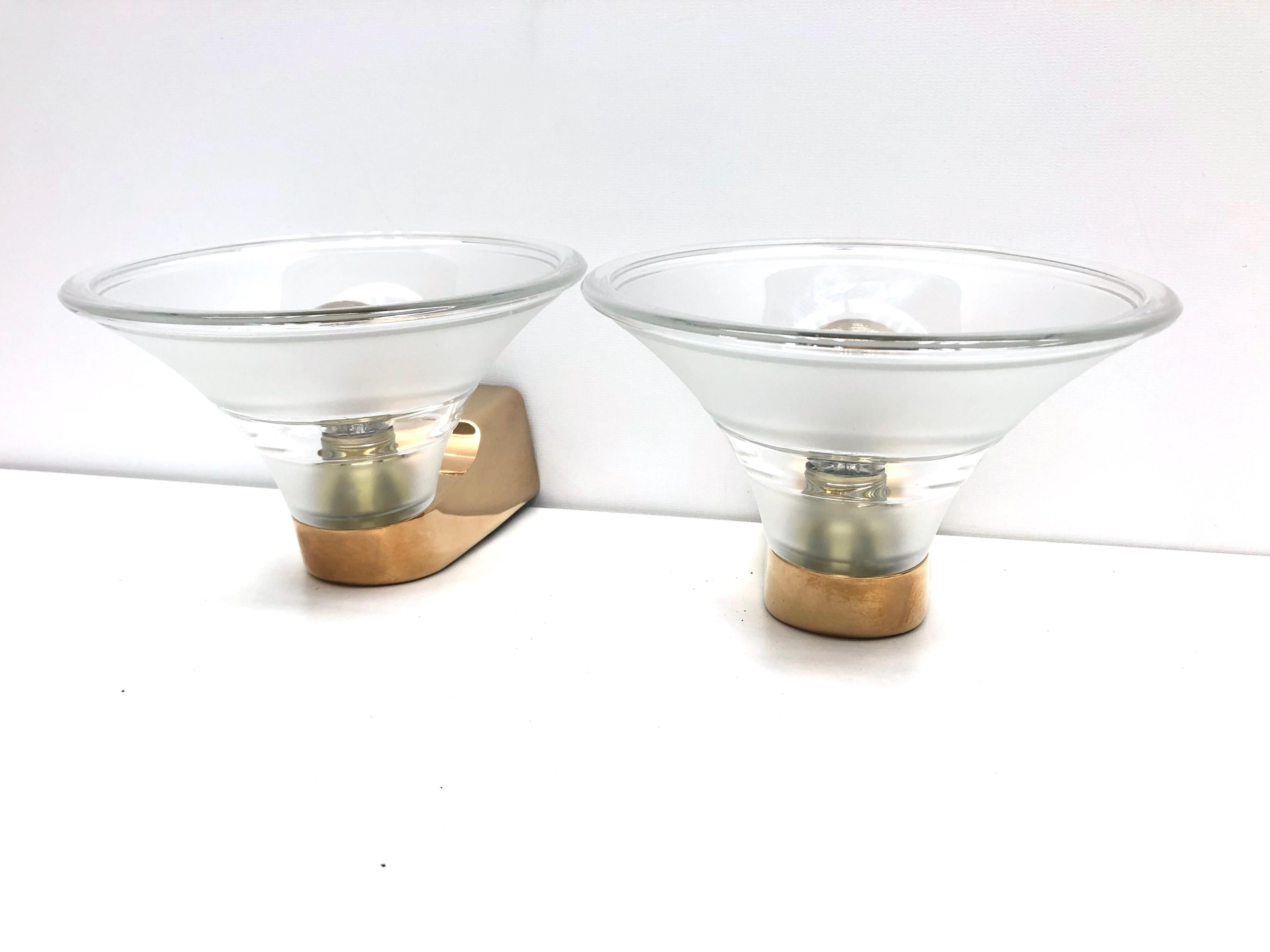 Pair of Art Deco style sconces. Beautiful clear glass on gold plated frames. Each fixture requires one European E14 / 110 Volt Candelabra bulb, each bulb up to 40 watts.