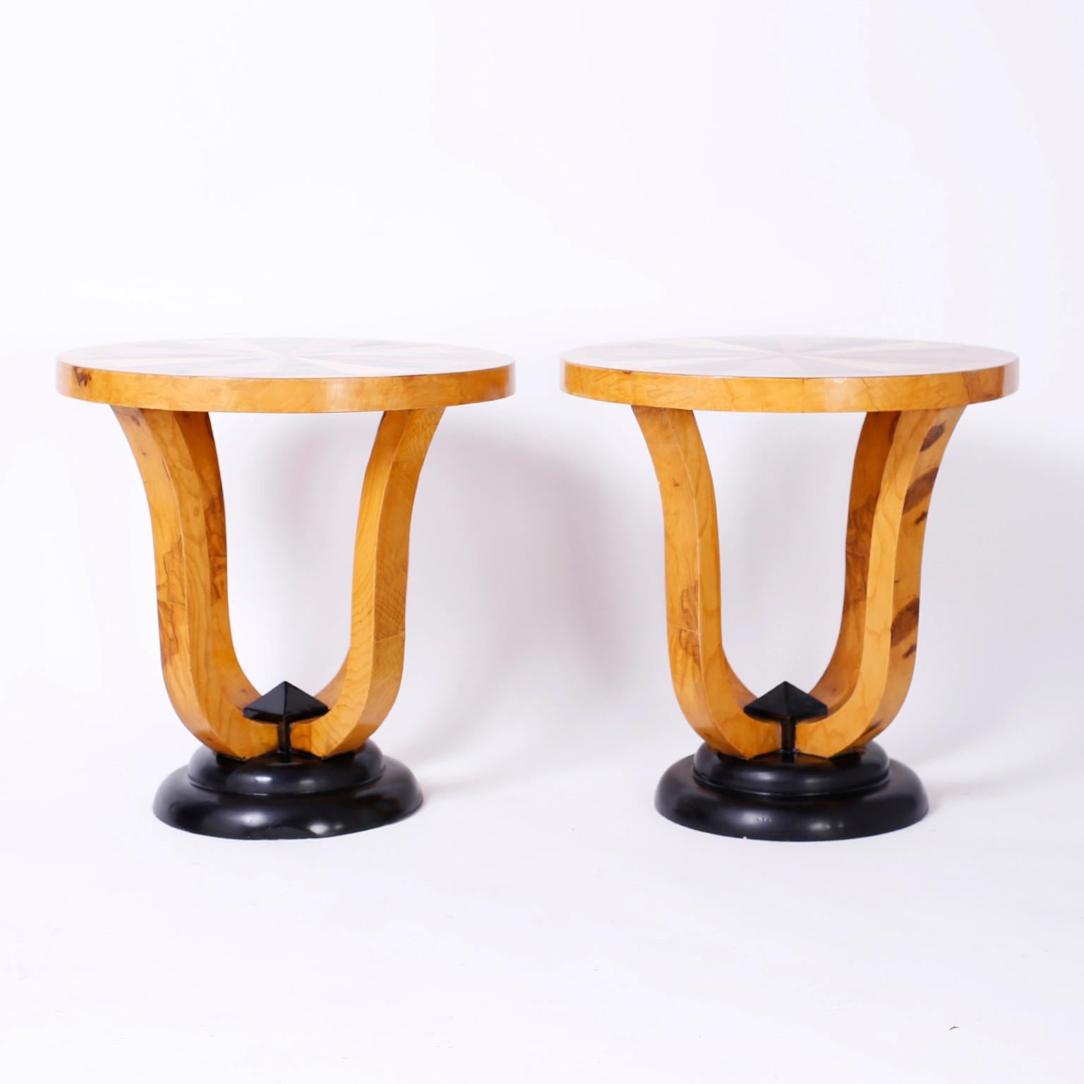 Pair of Art Deco style tables with round tops inlaid with mahogany, birch, pine and zebra wood in a pinwheel design.