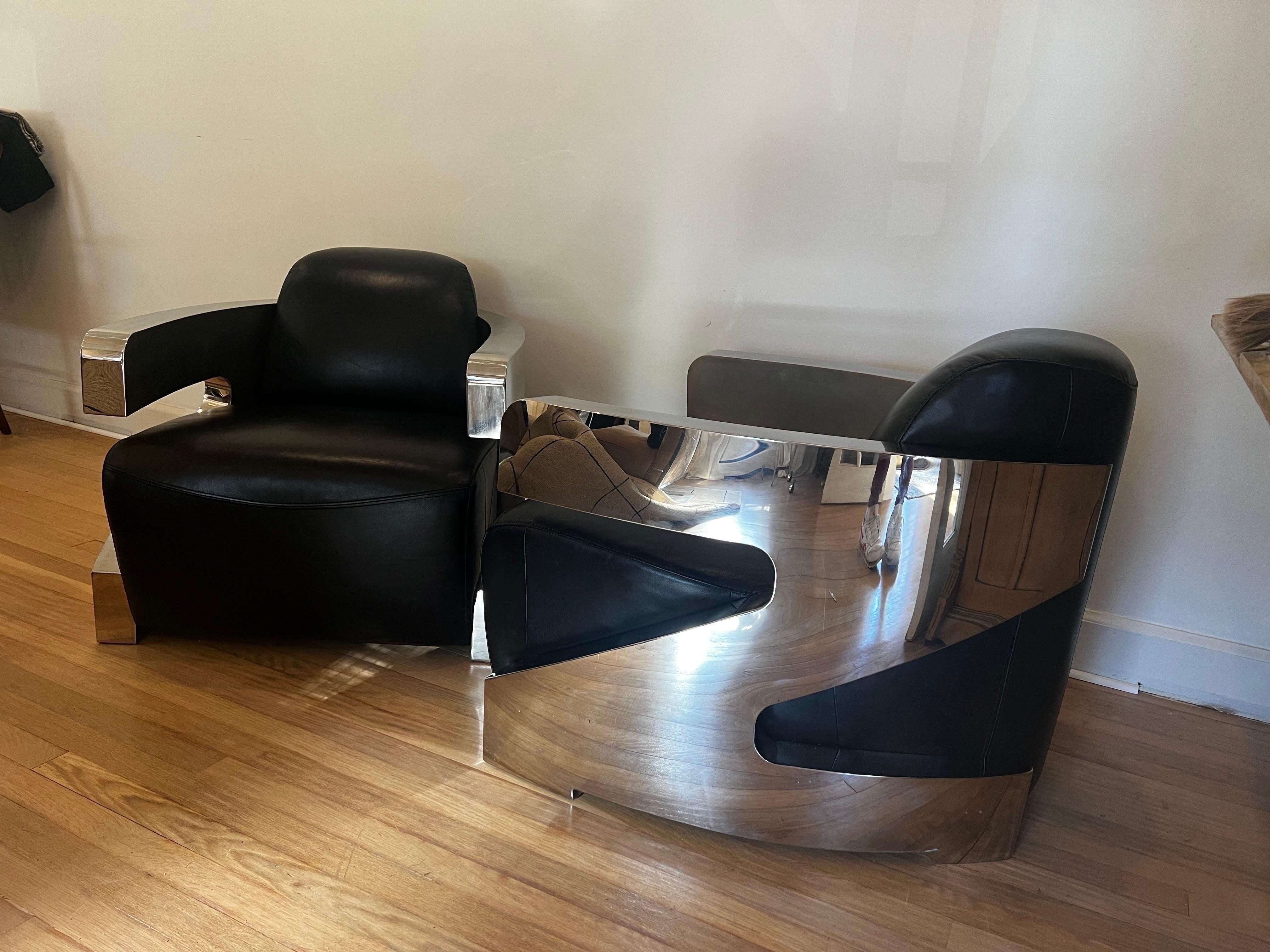 PAIR of Industrial Art Deco style round back lounge chairs with chrome frame and black leather upholstery.