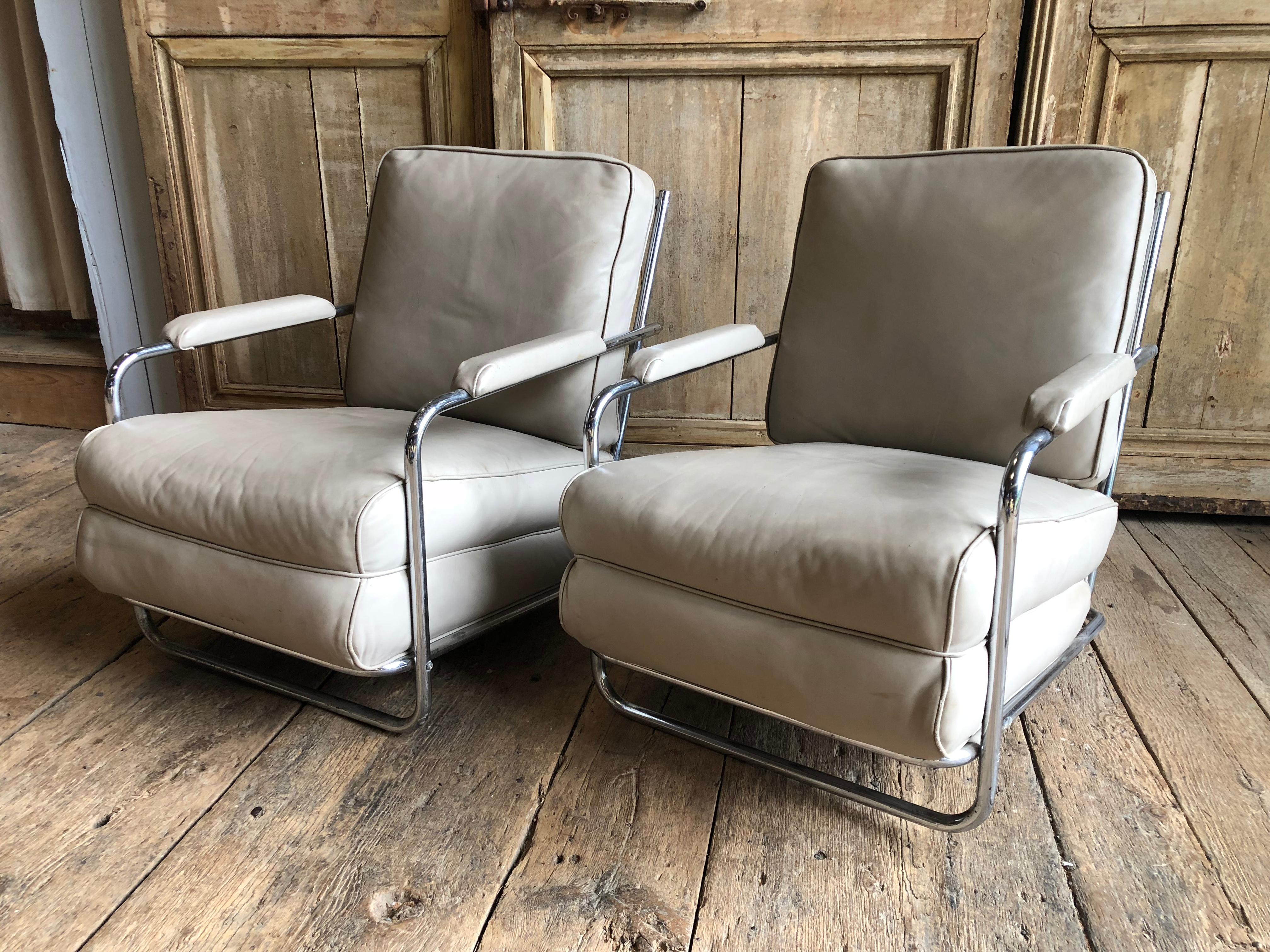 A pair of Art Deco Style chromed tubular steel framed lounge chairs with cream colored leather seats and backs, circa 1933 (in the Troy Sunshade Catalog 1933)