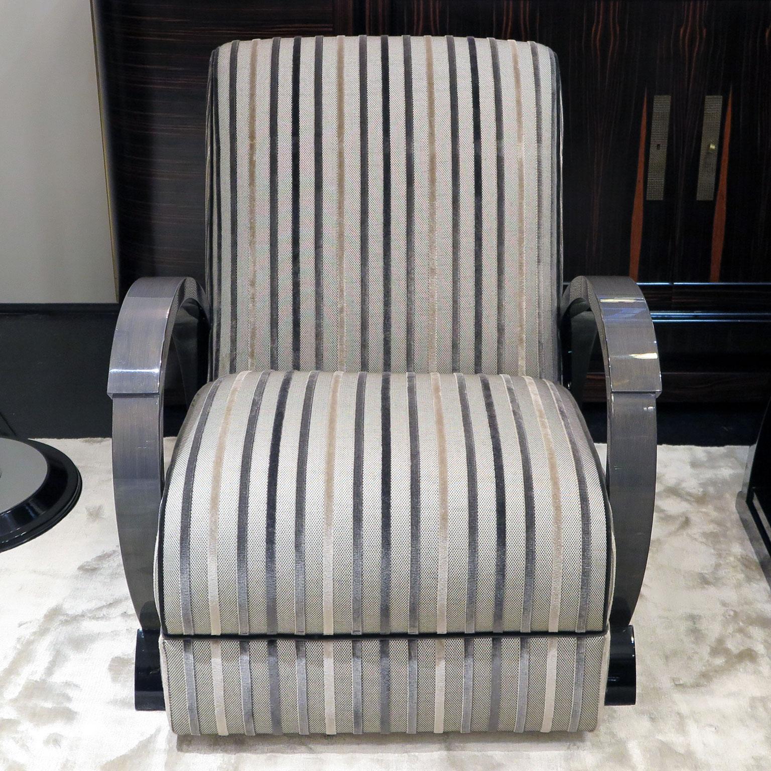 Pair of Classic Art Deco style chairs from our custom Anne Hauck Collection line. Shown here with the top of arms in grey maple with the rest of the frame in black lacquer, all with a high gloss finish. These lounge chairs are upholstered in a