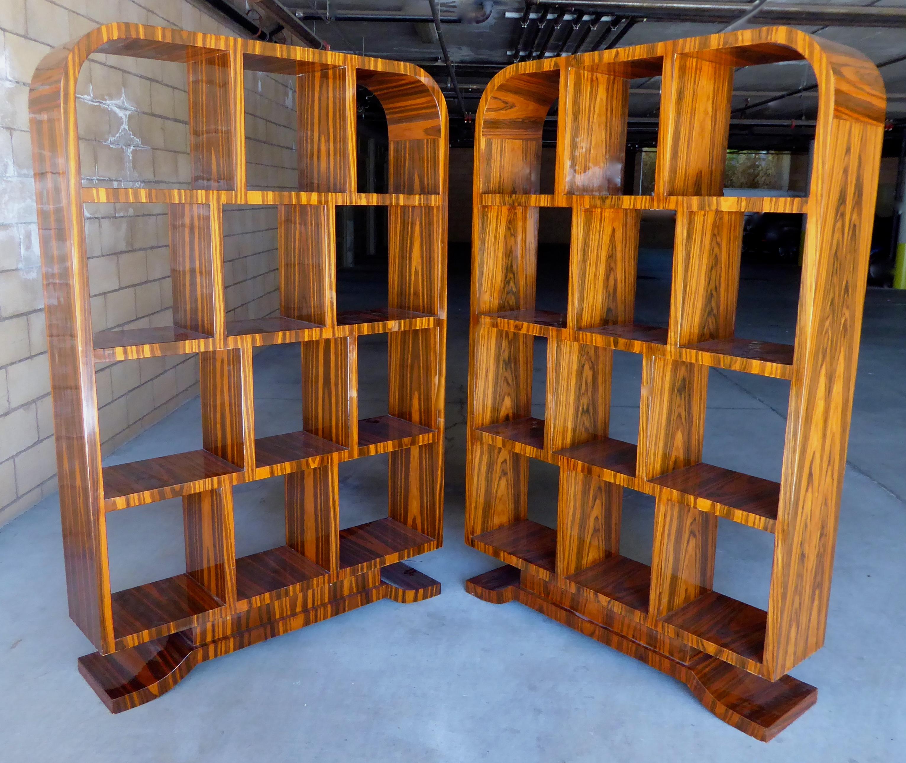 A pair of Art Deco style Macassar ebony bookshelves, circa 1980s. Choice ebony veneers cover literally every surface, including the undersides of all of the shelves. We believe that these were custom made due to the high quality materials that were