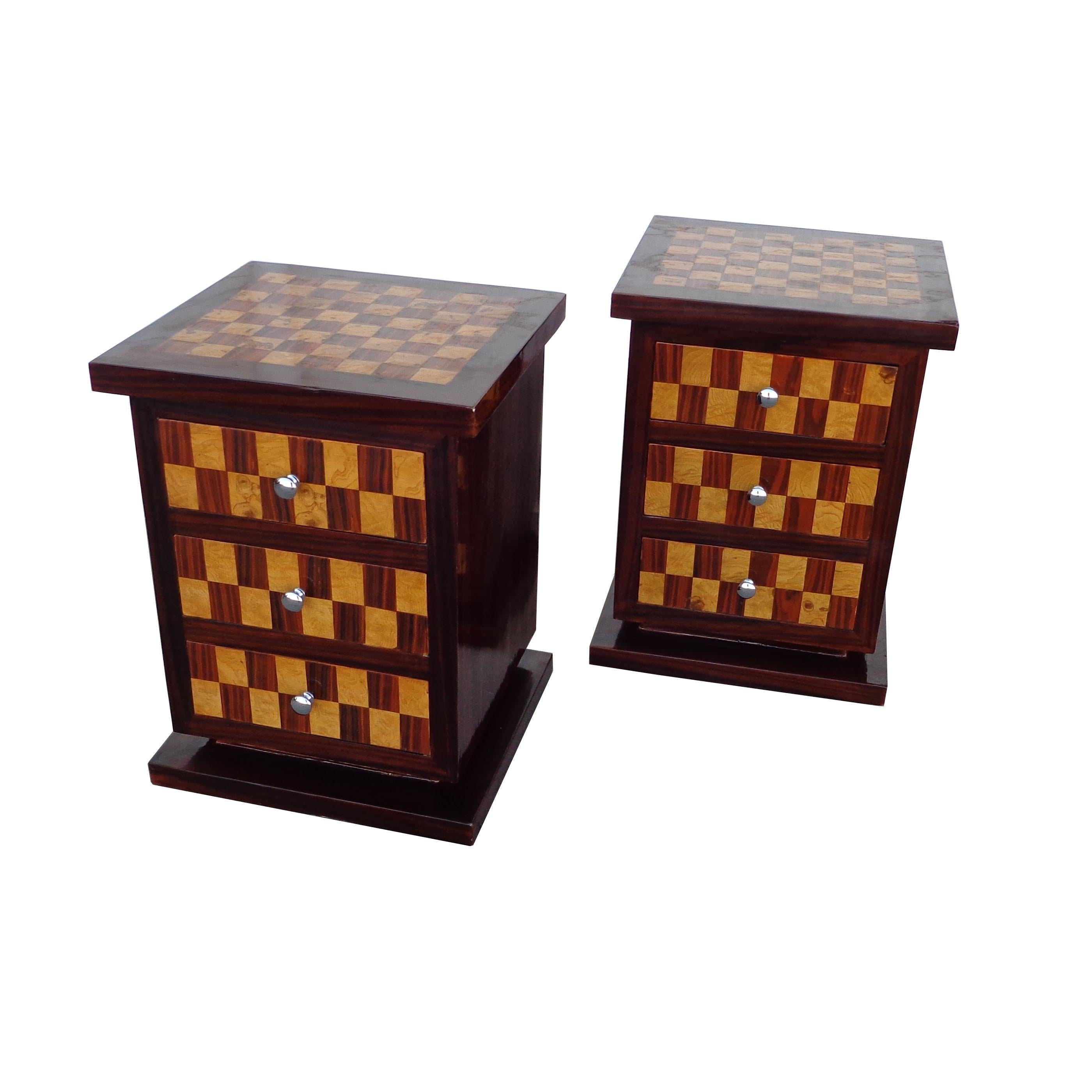 Pair of Art Deco style nightstands or side tables

Nightstands with a checkerboard pattern exotic wood parquetry on top and sides. Three drawers with nickel pulls. 
Beautifully finished backs.
 


  