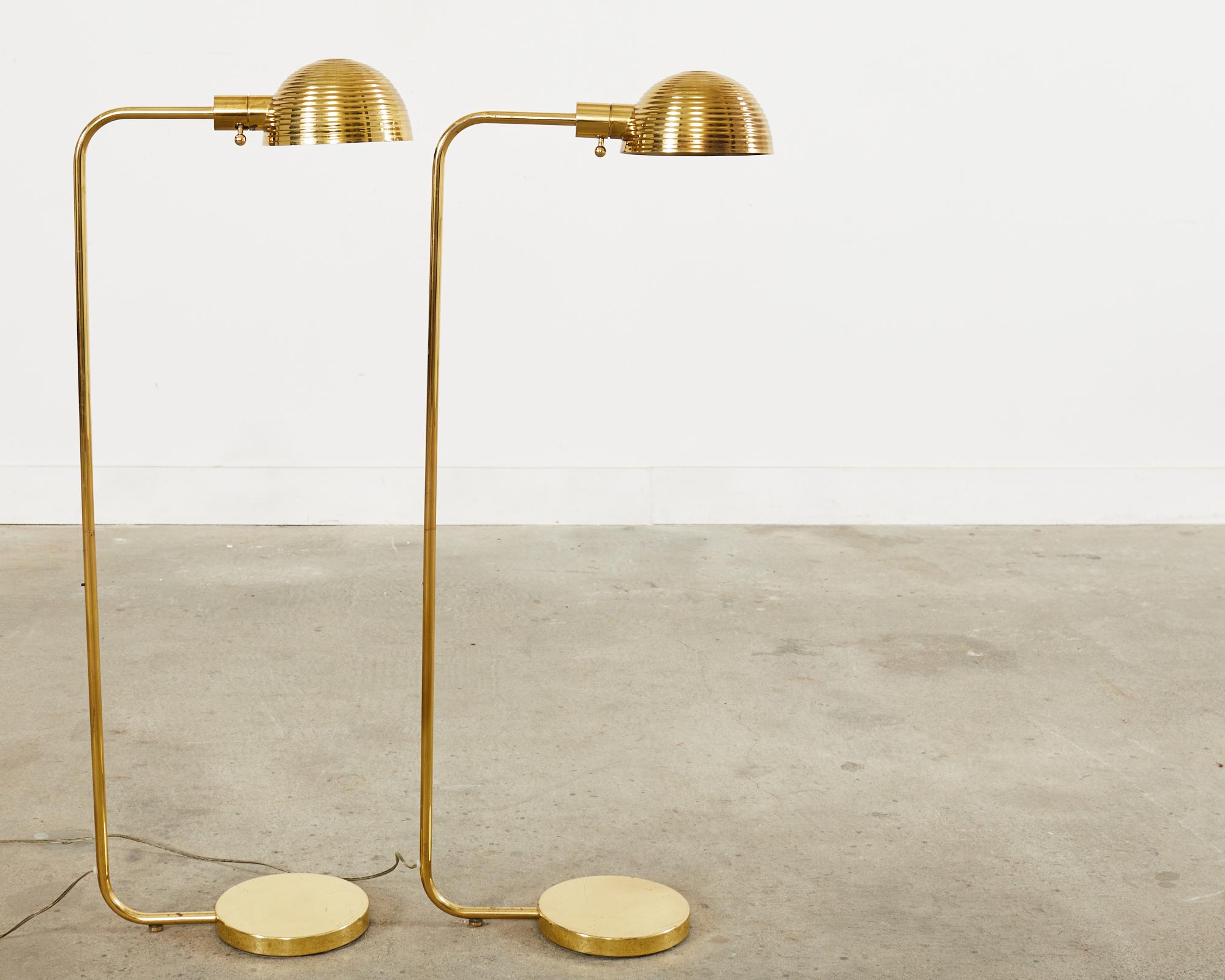 Stylish pair of brass task floor lamps designed by Harry Lawenda for Boyd Lighting Sausalito, CA. The matching pair of lamps feature a bee hive-shaped dome swivel shade with a reeded finish. The lights have a dimmer control switch and a gorgeous