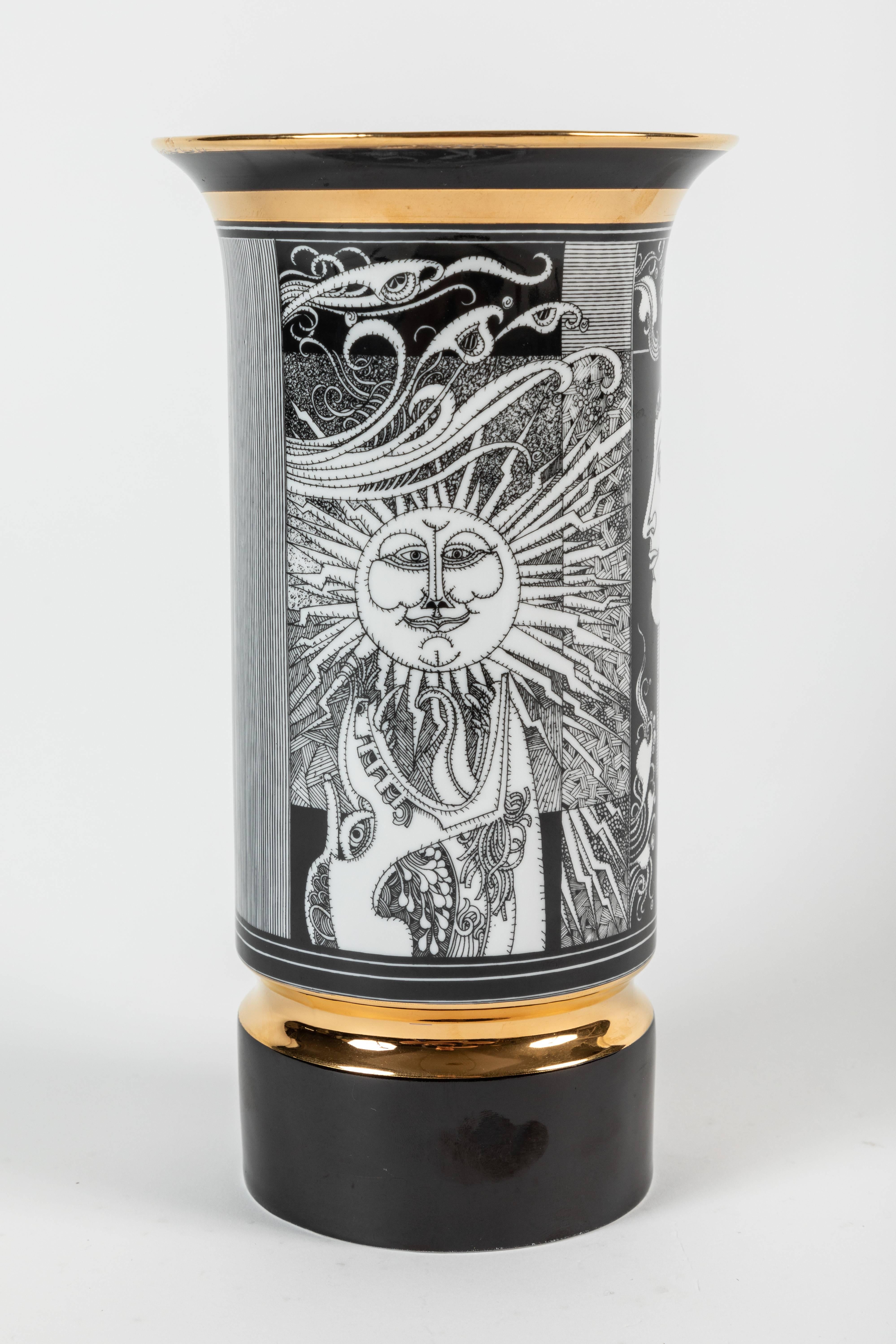 An exquisite pair of cylinder porcelain vases by Endre Szasz for Hollóháza. One vase features a sun, moon and goddess in a stylized art deco type design, and the other vase features a goddess overlooking a field of flowers and butterflies. Both of