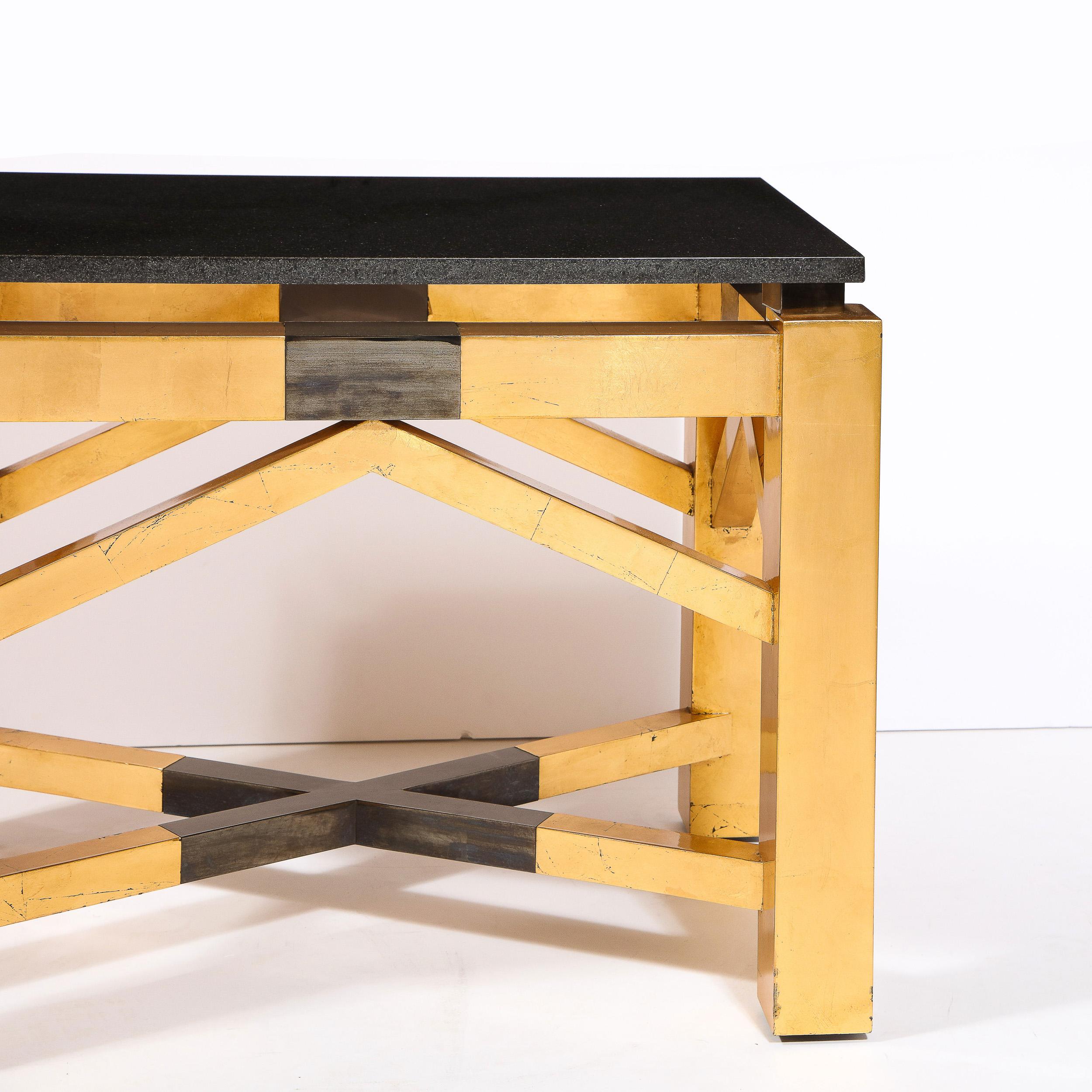 This bold and graphic pair of Art Deco Revival documented Lorin Marsh end tables were realized in the United States circa 1985. They feature volumetric rectangular legs with x form cross slats in gilded wood with gunmetal detailing at the center.