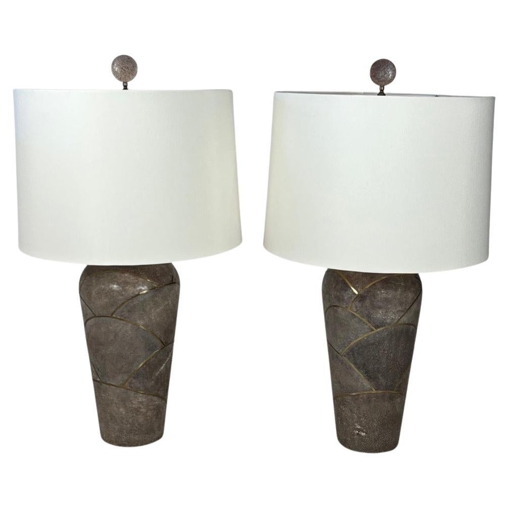 This pair of table lamps that are attributed to Karl Springer are an exquisite lighting pieces that elevate any living space. These lamps are crafted from a combination of Shagreen and Bronze with some Art Deco geometric designs that make them a