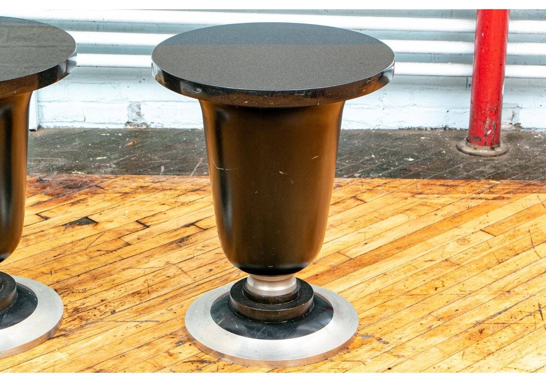 A rare pair of cone form side or end tables in the Art Deco style with probable dating to the 1940s. Black painted urn form pieced wood (see photos) stands with steel collars on the stepped painted wood bases. Mounted on steel bases with black