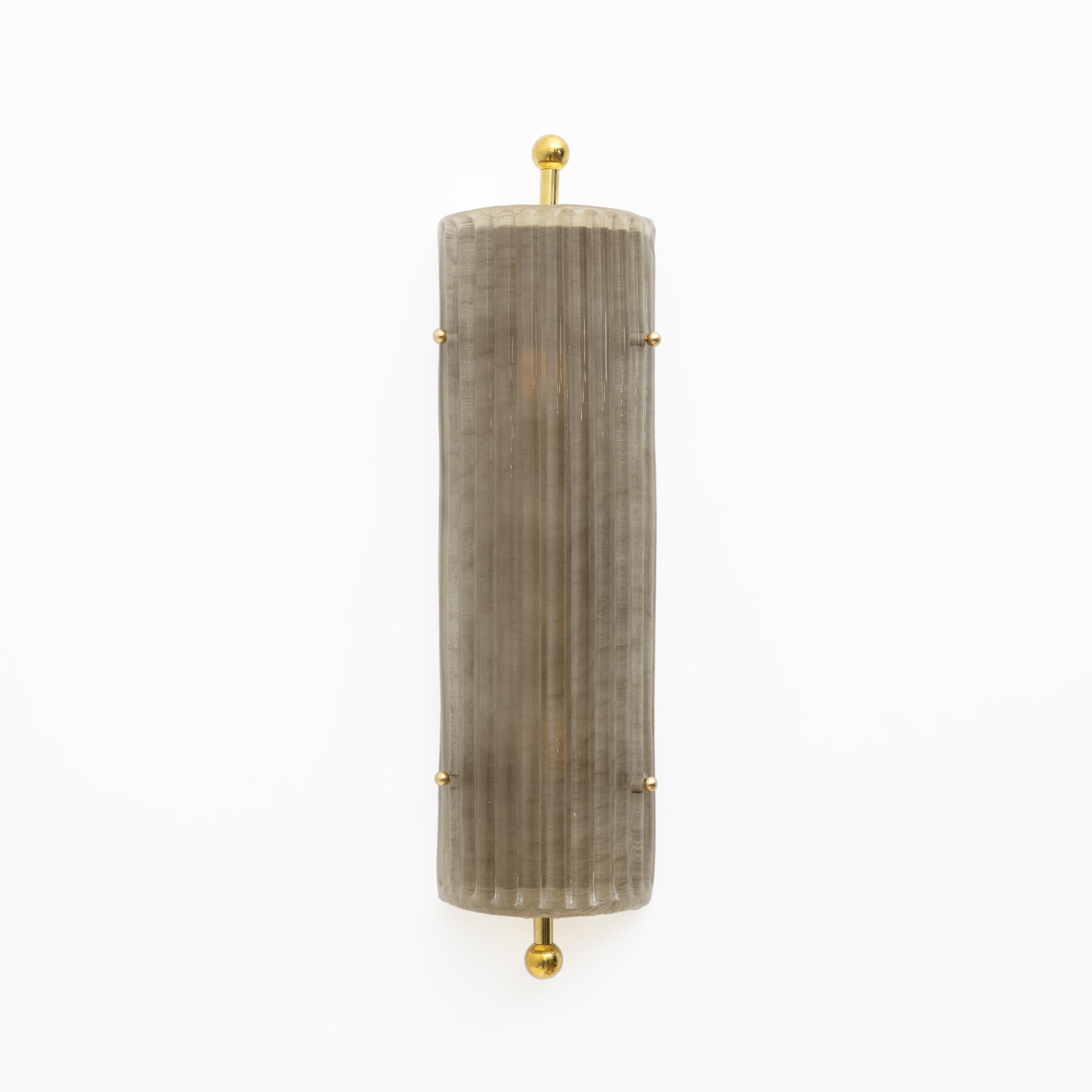 Pair of Murano glass and brass flush mount sconces with an Art Deco inspired bezel, with a timeless yet elegant aesthetic. Perfect for creating the perfect warm glow in any interior. Each sconce is wired to US standards with an E12 socket or