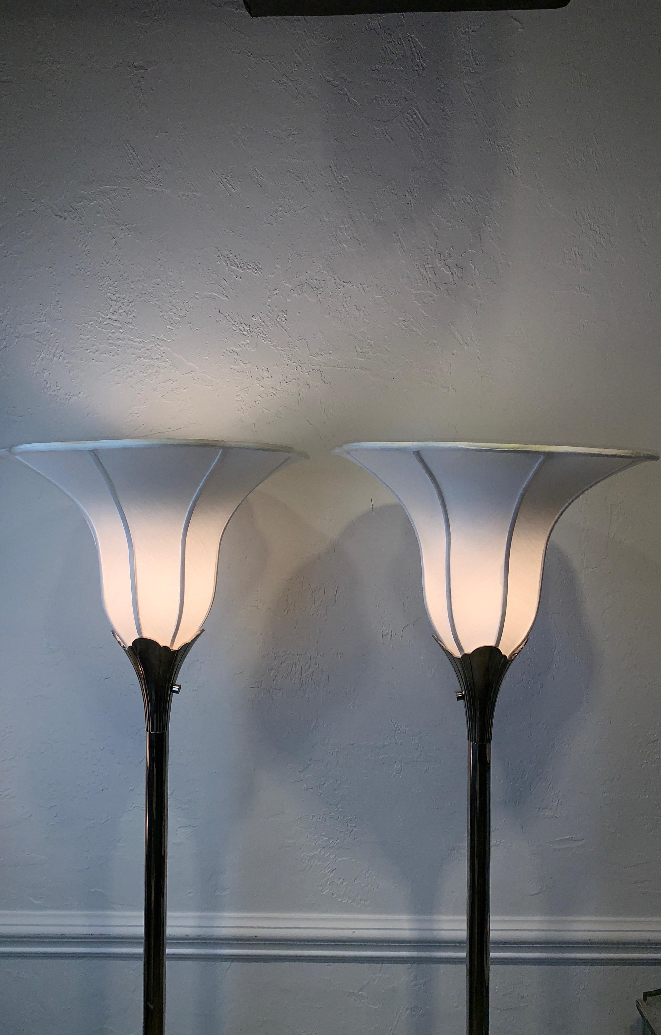 Pair of floor lamps / torchieres by Stiffel. Nickel plated over brass. In the manner of Tommi Parzinger who designed for Stiffel in the mid-20th century.