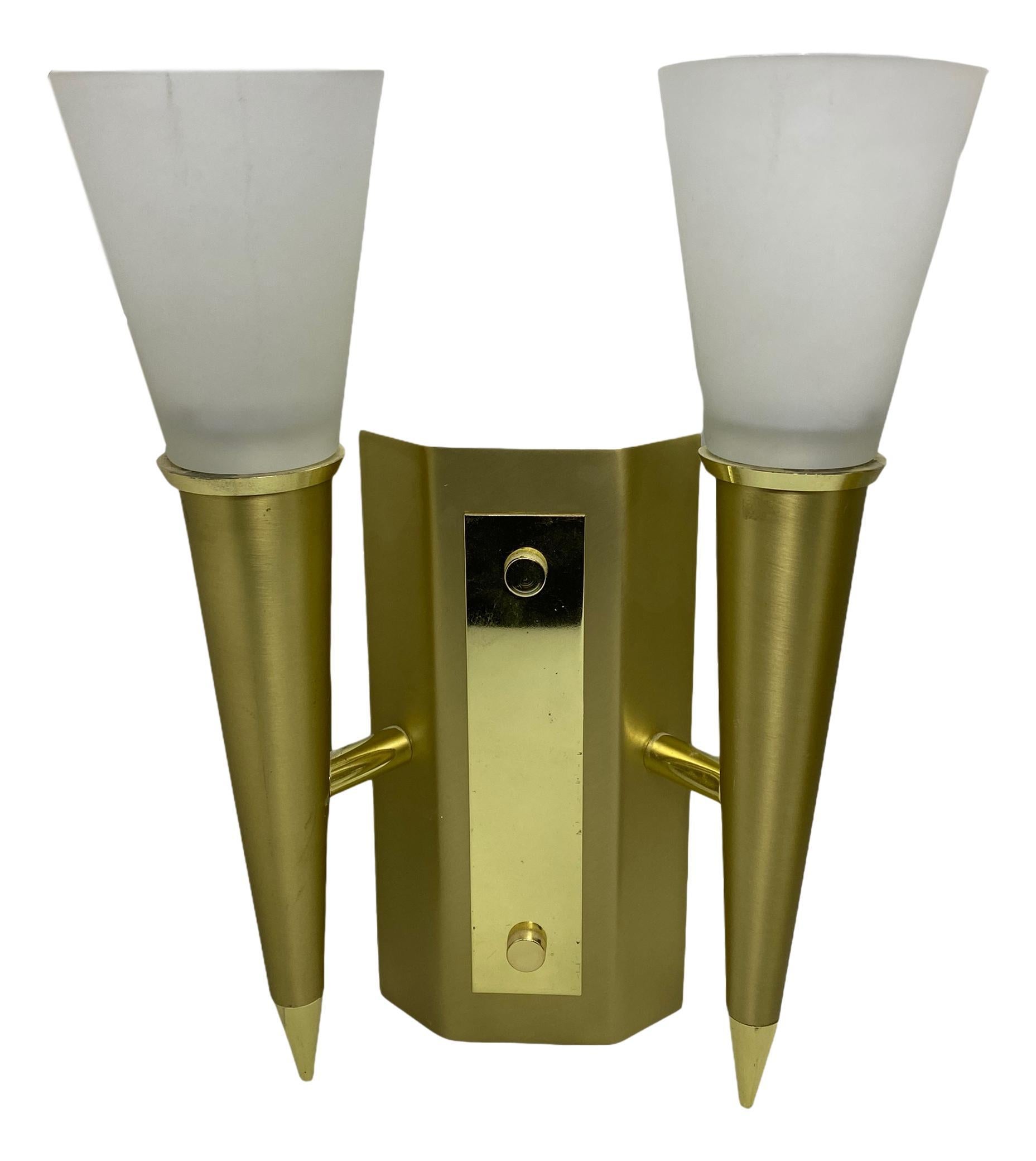 Pair of Art Deco style sconces in the shape of a torch. Each fixture requires two European E14 candelabras bulbs, each bulb up to 40 watts. The wall lights have a beautiful patina and gives each room an eclectic statement. Made of brass and satin