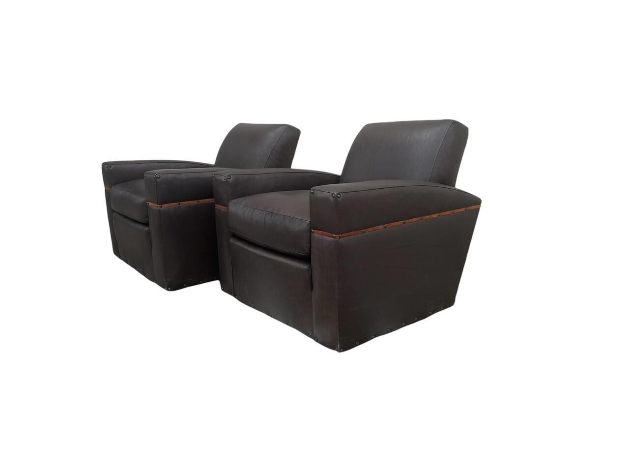 Indulge in timeless elegance with this pair of exceptional Classic style lounge chairs by Whittemore Sherrill. Crafted from 100% top grain artisan leather, each chair boasts hand burnished detailing for a luxurious finish. The exquisite nailhead