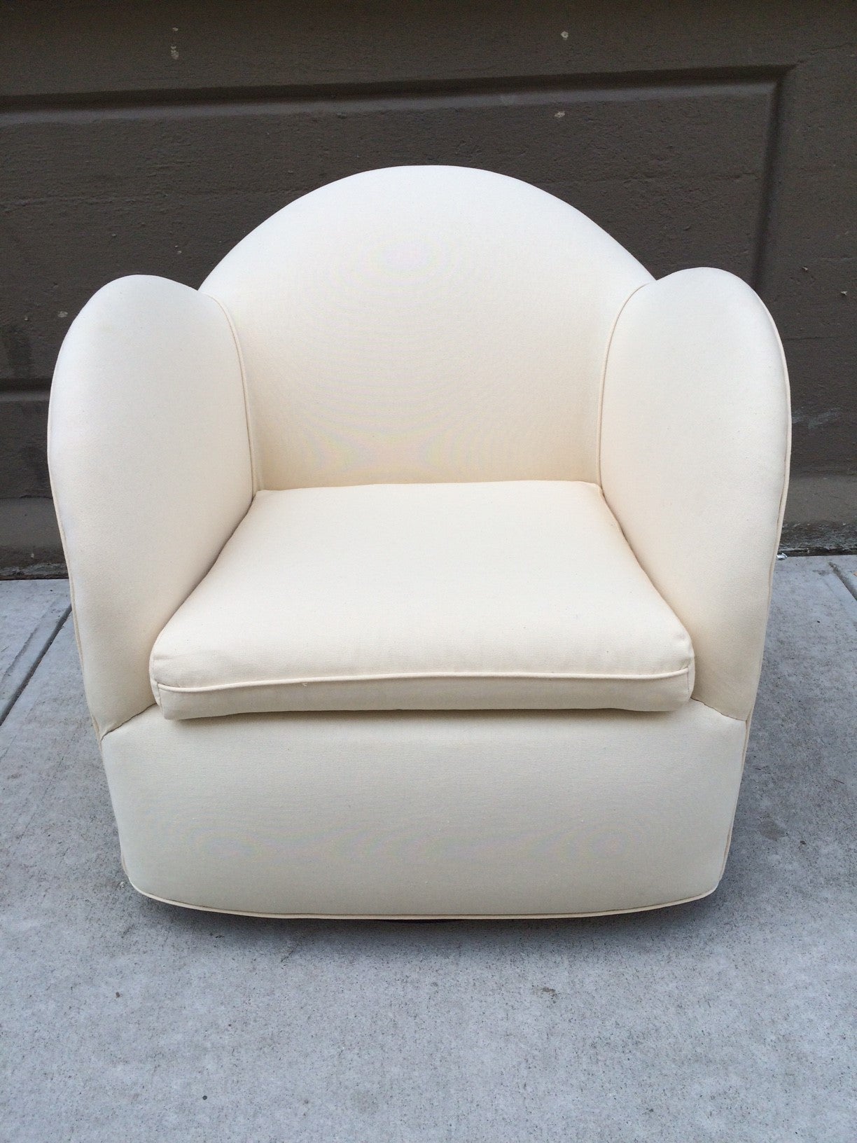 Pair of Art Deco Swivel Cloud Lounge Chairs.  Upholstered in a linen blend fabric. Has a black lacquered base.