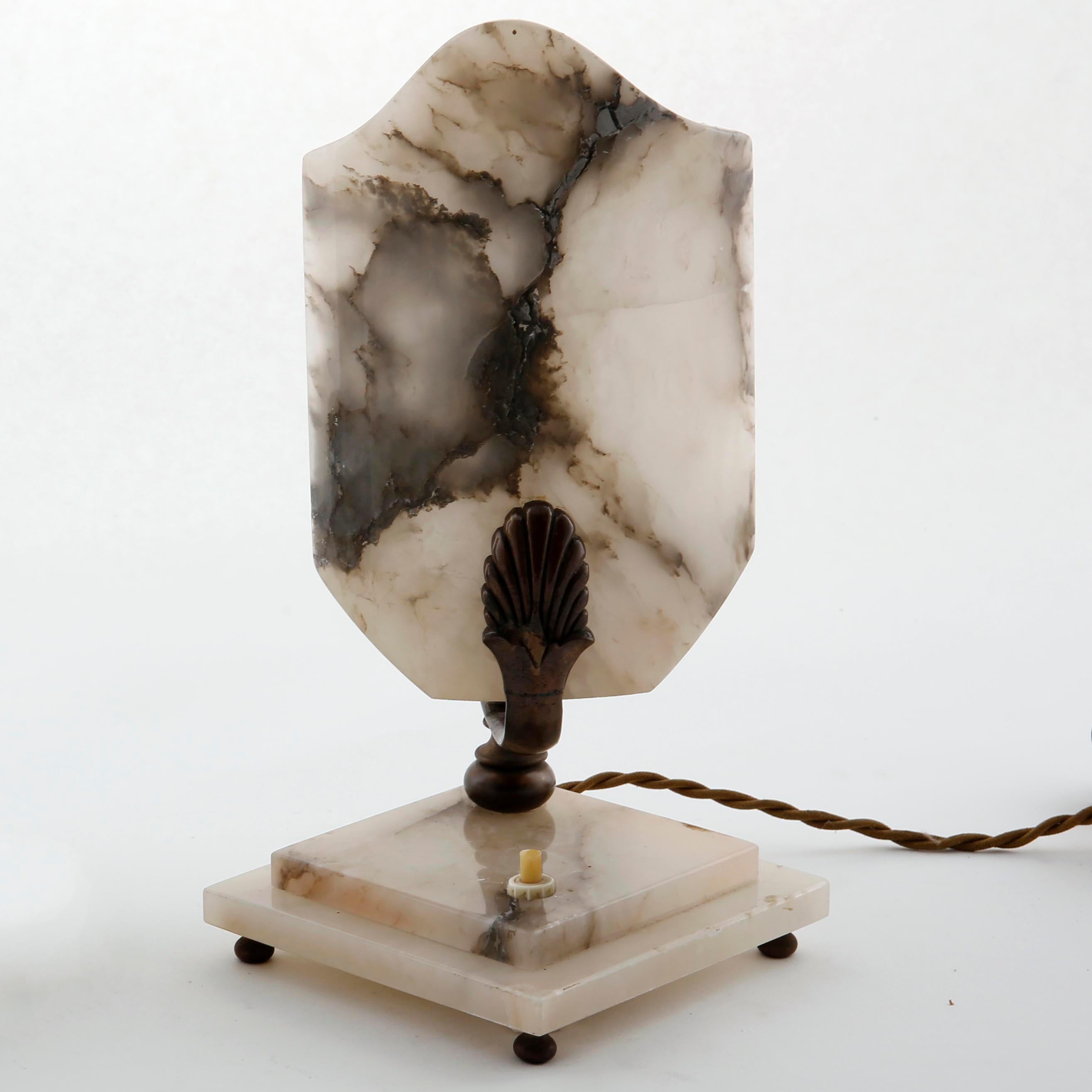 A pair of French Art Deco table lamps made of alabaster and bronze, manufactured circa 1930.
The cords will be renewed with textile cords before shipping. The color can be chosen.