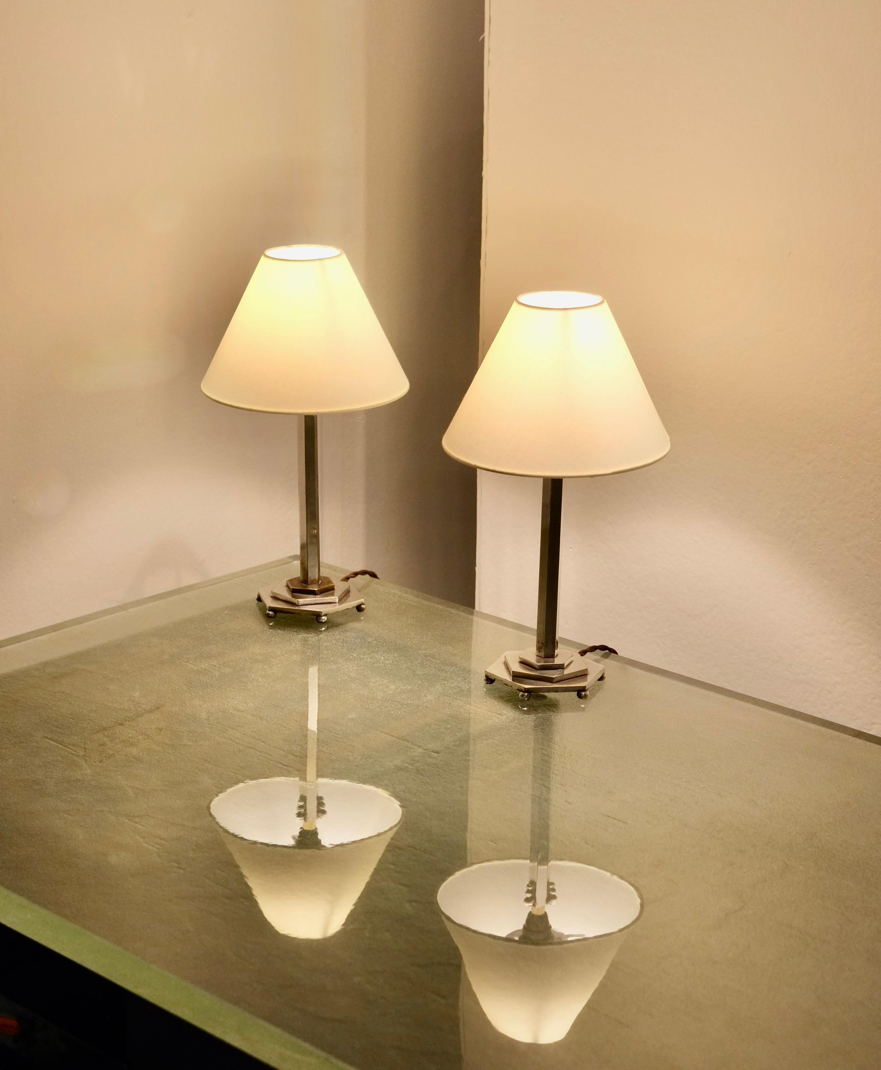 A pair of Art Deco nickel plated table lamps.

France, circa 1930’s.

Rewired and PAT tested. Exposed brass to the plate of the base of one of the lamps (see photo). 

H 28 W 10 D 11 cm