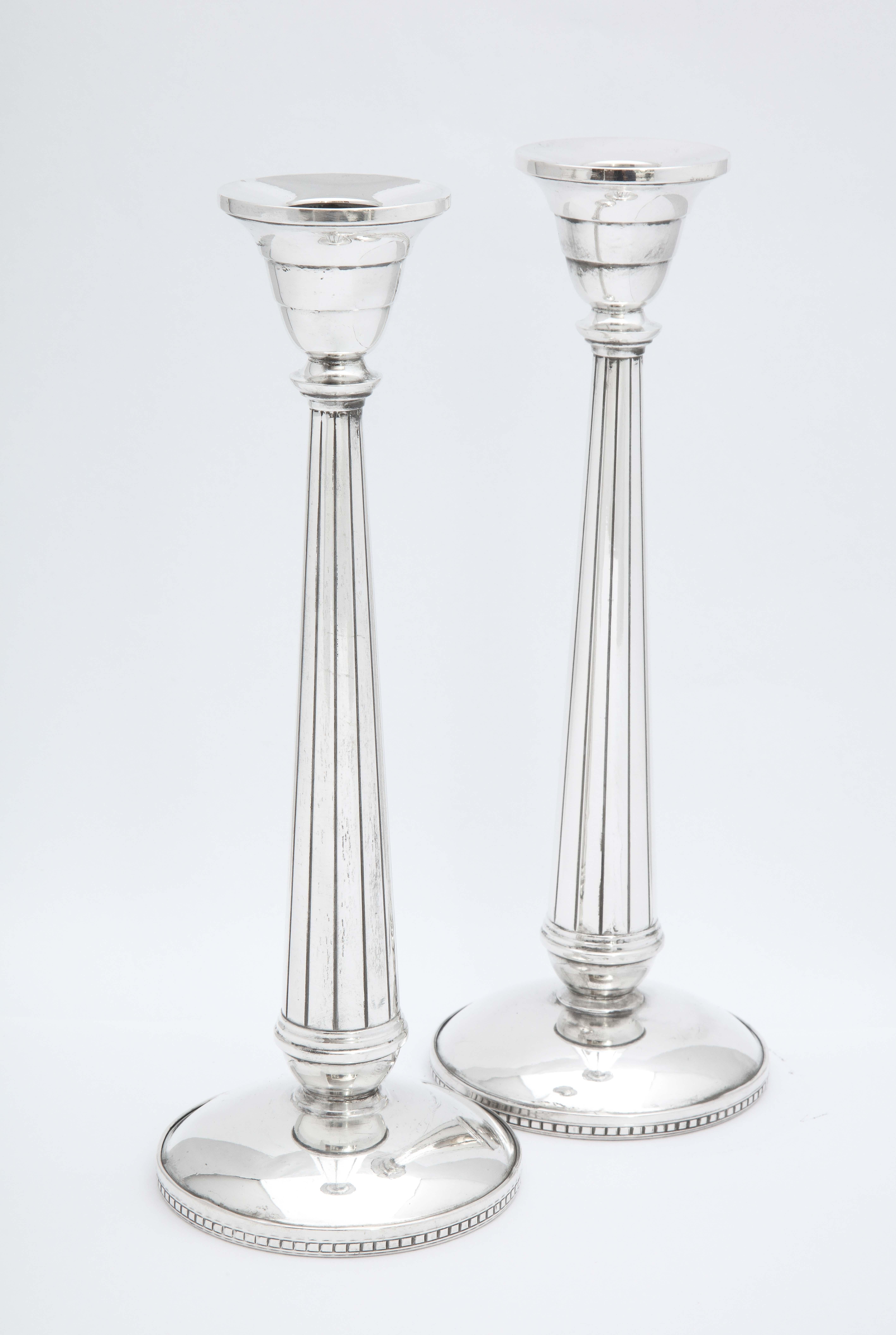 Pair of Art Deco, tall sterling silver candlesticks, The Webster Silver Corp., North Attleboro, Mass., Ca. 1930's. Each candlestick measures 9 inches high x almost 3 3/4 inches diameter across its base x 2 inches diameter across candle cup. Some
