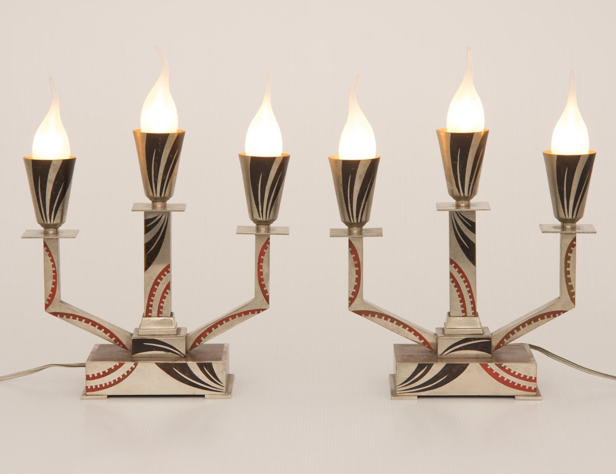 An impressive pair of art deco candelabra lamps.
triple branch candelabra lamps, Nickel Plated Steel with Red & Black Lacquered Geometric Design.
Designed by M offner.
H:34 cm W: 25 cm D: 11 cm
French c 1930