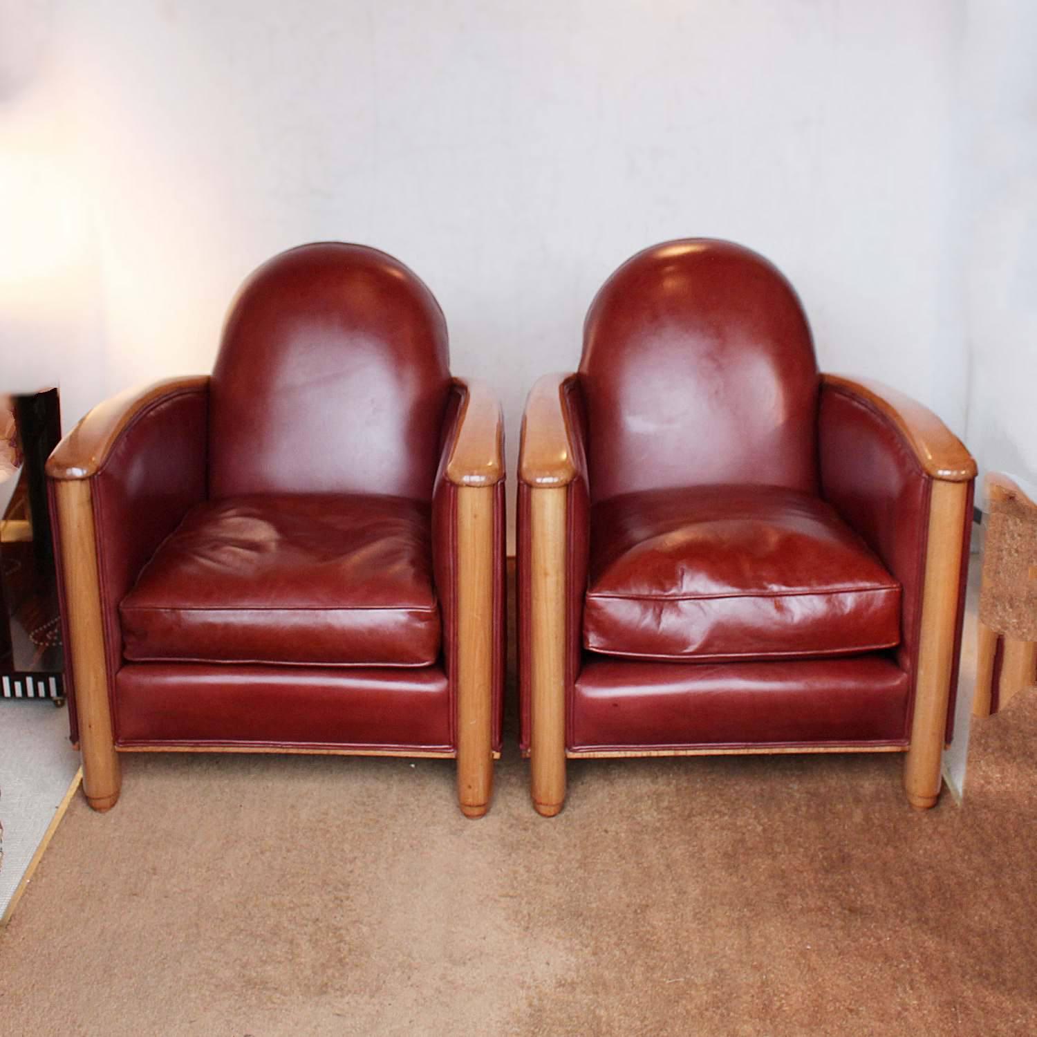 A pair of Art Deco chairs. fruitwood arms and legs, upholstered in chestnut leather.