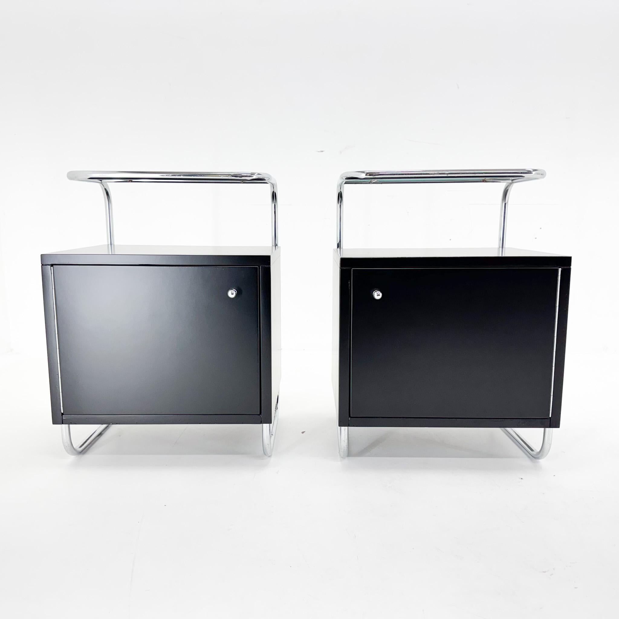 Set of two tubular night stands. The wooden parts are newly laquered. The chrome and glass are in original condition with some signs of use (see photo).
