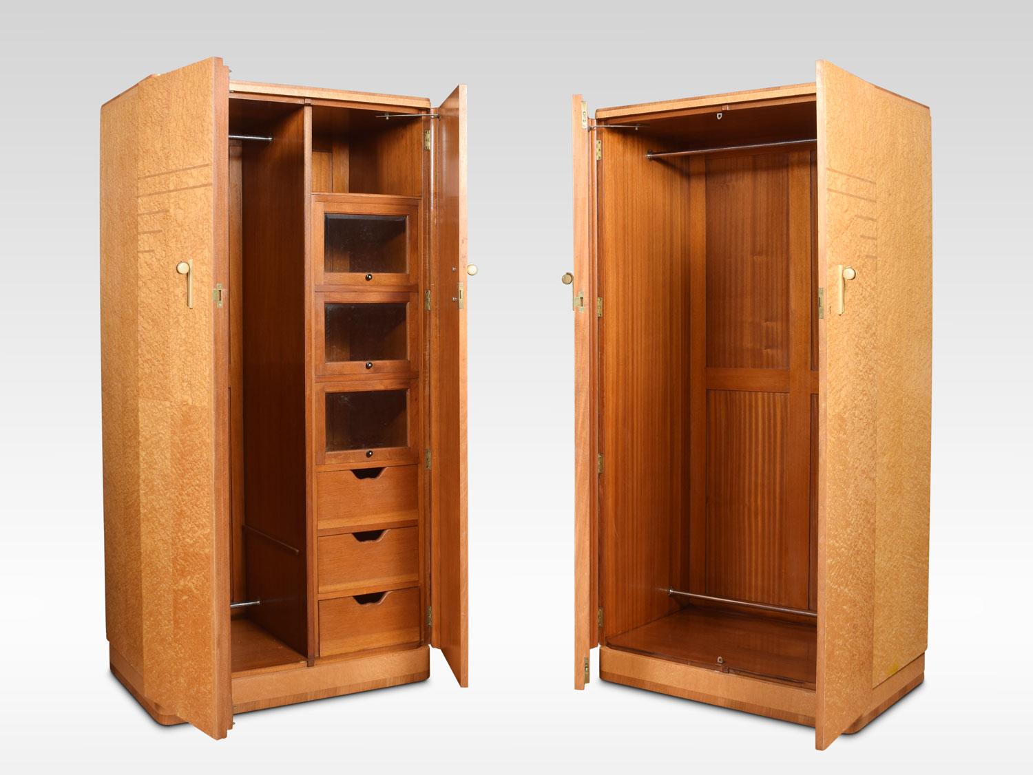 A pair of maple and walnut Art Deco wardrobes, both having two large doors with original Bakelite handles. One combination wardrobe fitted with glazed compartments, drawers and hanging space. The other wardrobe fitted with large hanging rail. All