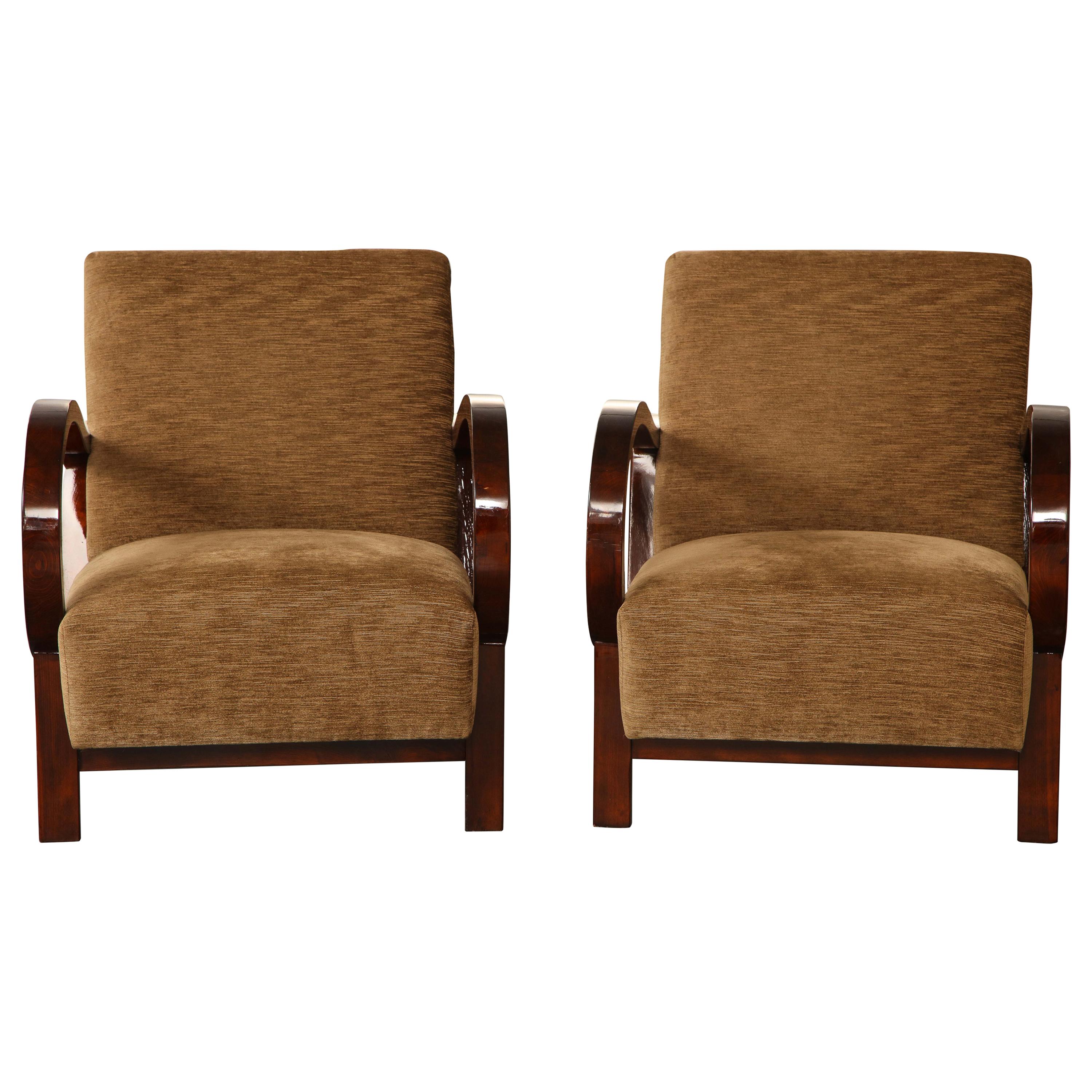 Each with brown linen velvet upholstered back and seat and deep mahogany-stained wood frame, including dramatically curving armrests. Generous proportions but not overscaled.