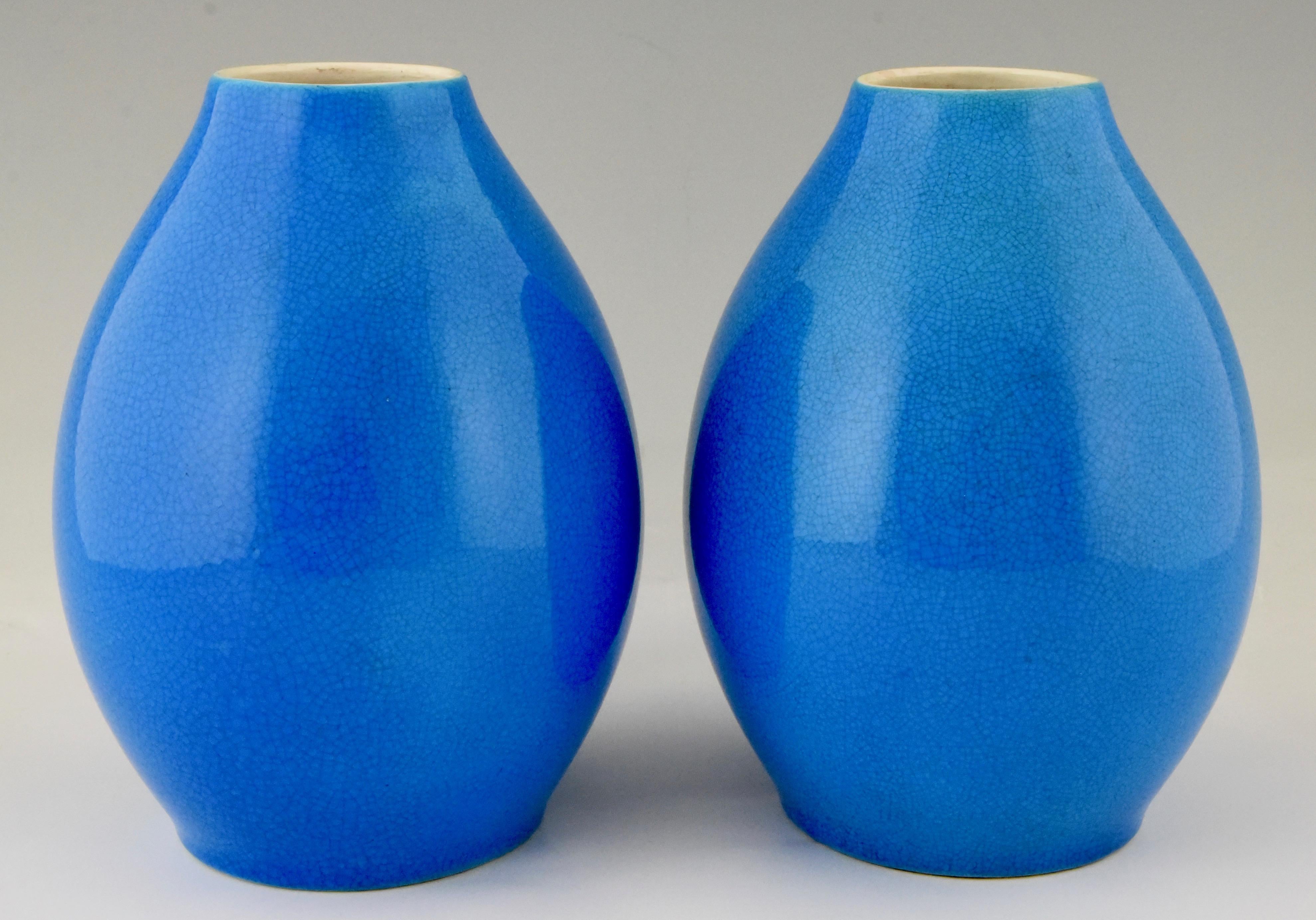 A pair of Art Deco blue craquelé vases by Boch Freres La Louvière.
Belgium, 1925. 

Similar vases are shown in the book? 