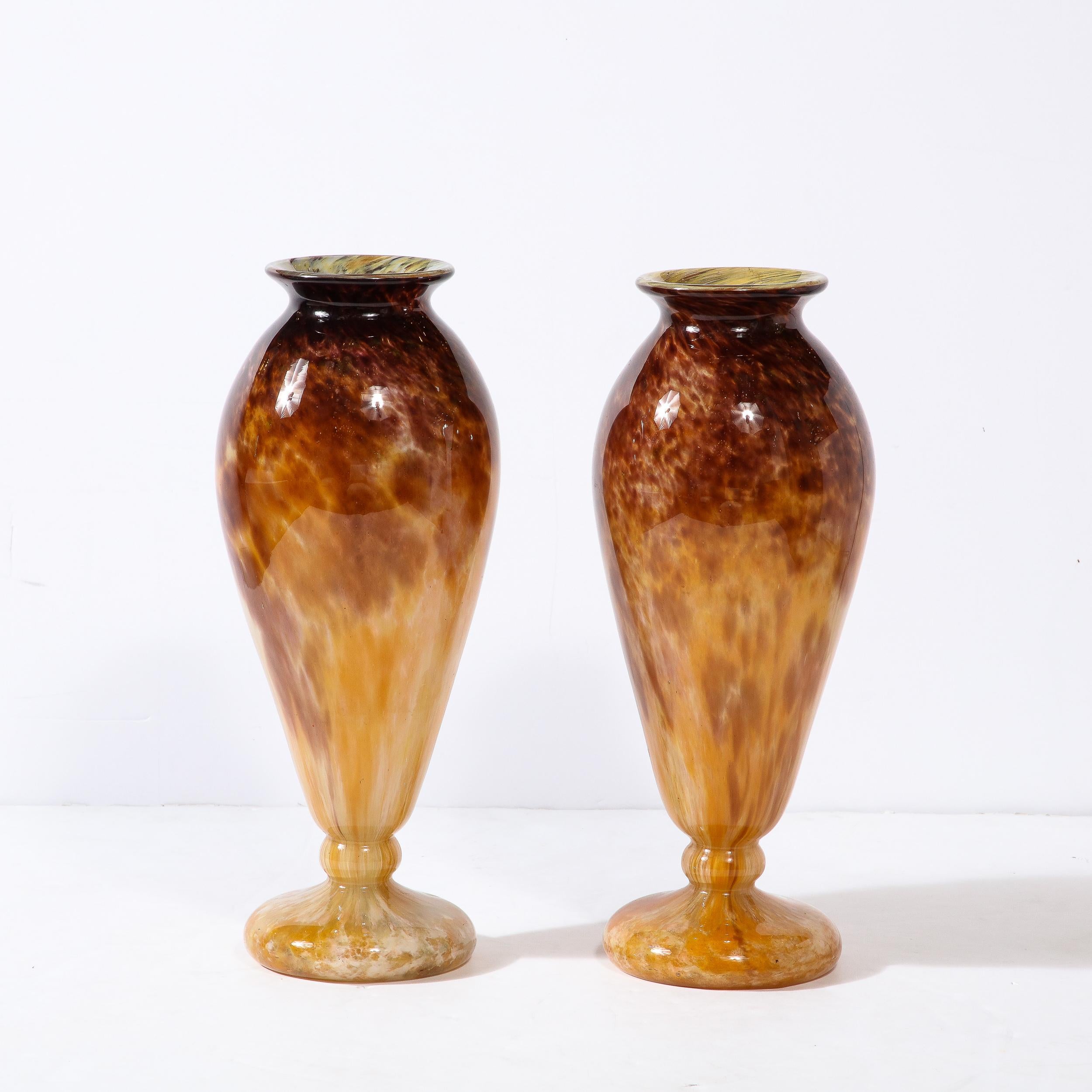 This gorgeous pair of Art Deco Vases in Smoked Amethyst & Amber Hued Glass were made by Schneider, and originate from France, Circa 1925. With a large profile and exceedingly elegant proportions, they feature an expansive openings that lead to a