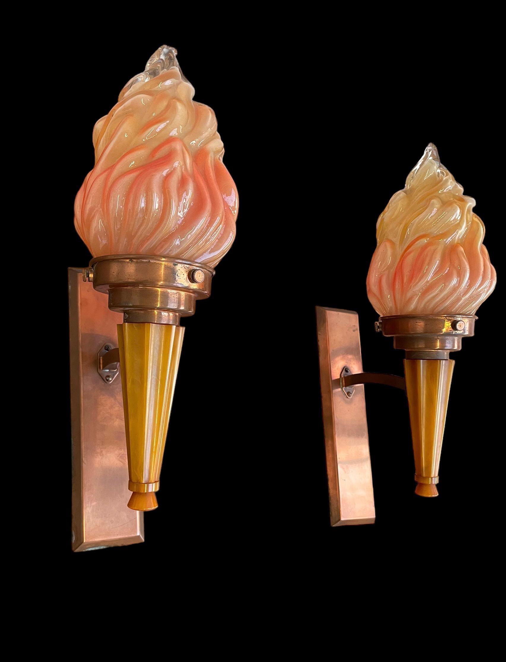 A pair of Art Deco wall lights, with flame effect glass shades and mounted in attractive butterscotch and yellow phenolic. The back plates and mounts in copper and just rewired. In very good condition.
Height of plinth: 26.5cm
Width of plinth: