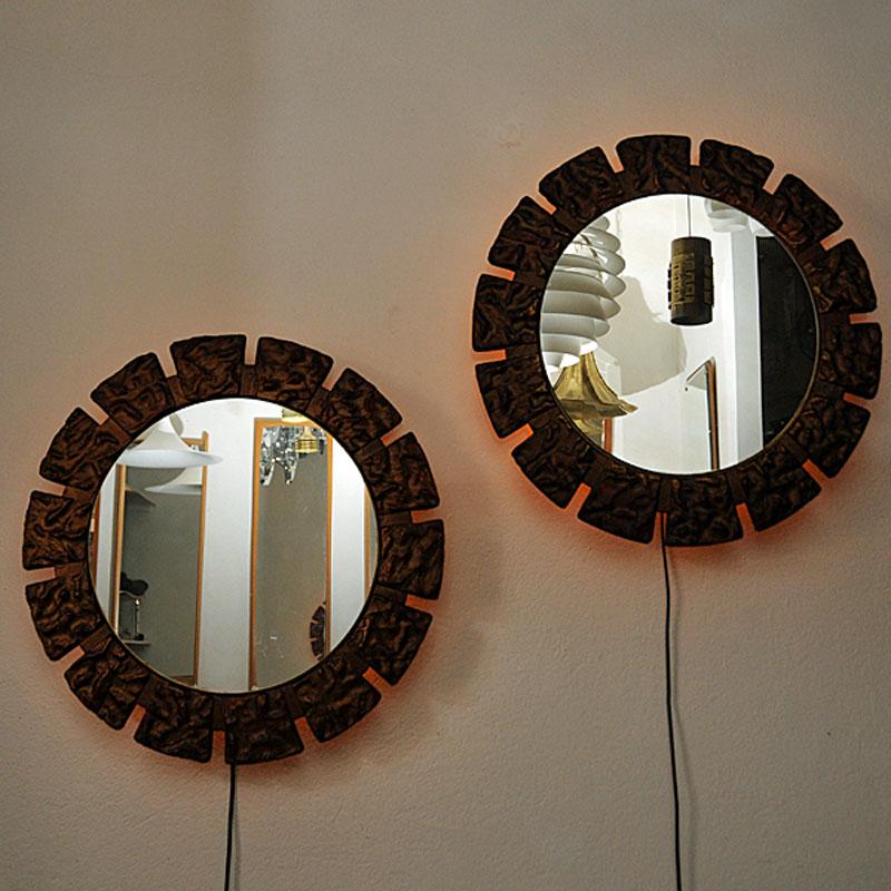 A pair of rare and beautiful Art Deco wall mirrors with lovely ligth flowing out in the back. Gives a nice and shiny light in darker rooms. Massive decorated and painted frame with attractive sculpture decorations around. Mirrors and light