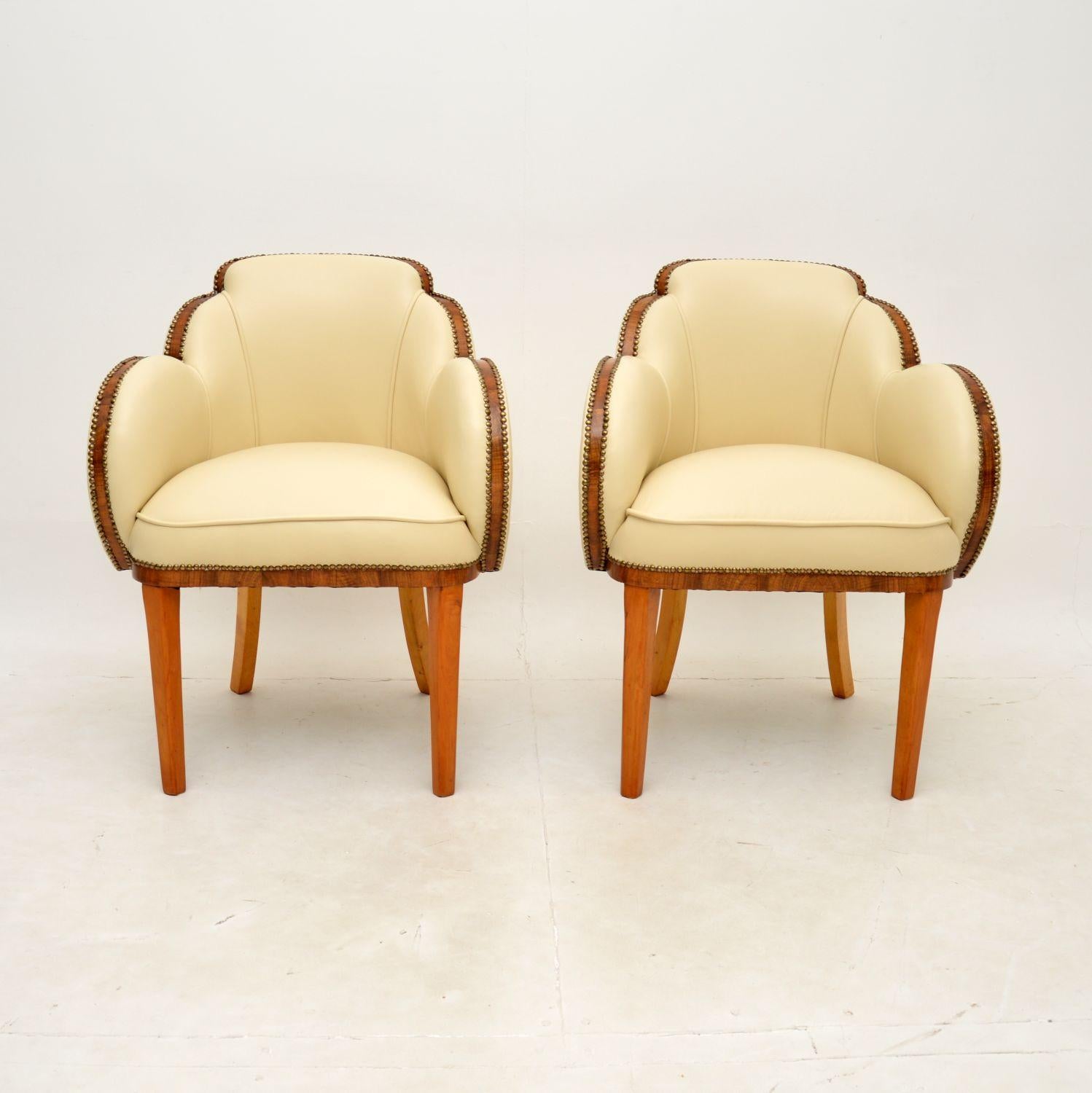 A fantastic pair of Art Deco walnut and Leather cloud back armchairs by Epstein. They were made in England, they date from the 1920-30’s.

The quality is outstanding, they are beautifully designed with cloud shaped backs, walnut banding around the