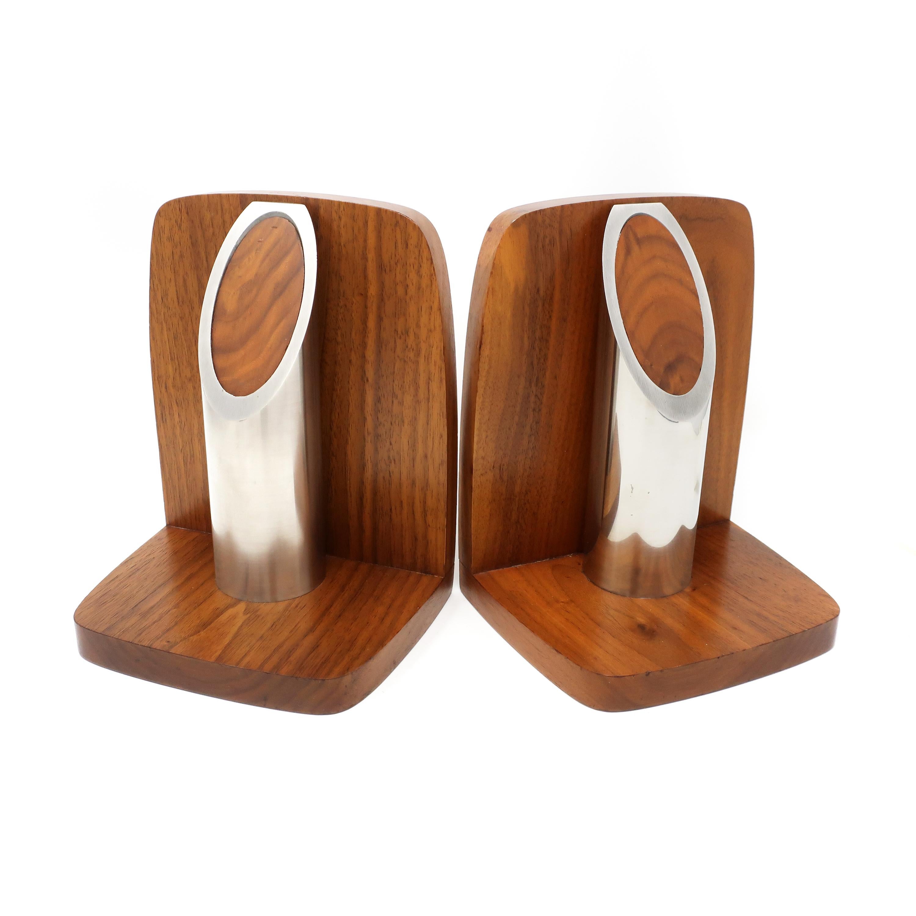 A lovely pair of Art Deco or early Mid-Century Modern bookends. Constructed from walnut with an aluminum cylinder cut at an angle filled with a walnut insert. Felt on underside, sticker on rear (reads “Solid American Walnut”), and no maker’s mark.