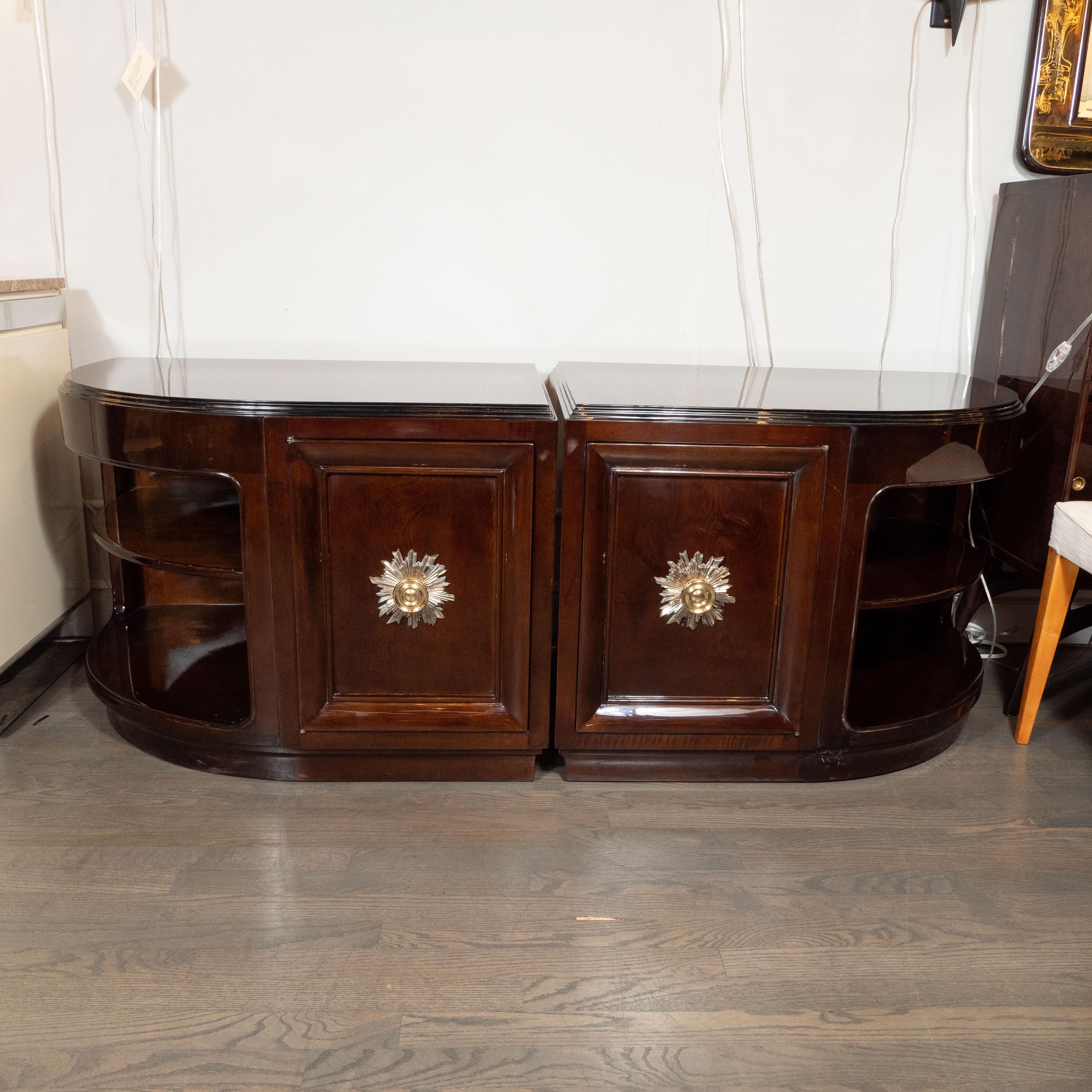 This stunning pair of Art Deco bookmatched walnut end tables/ nightstands were realized by the esteemed maker Grosfeld House by Lorin Jackson circa 1945. They feature streamlined fronts with beveled skyscraper style detailing in black lacquer