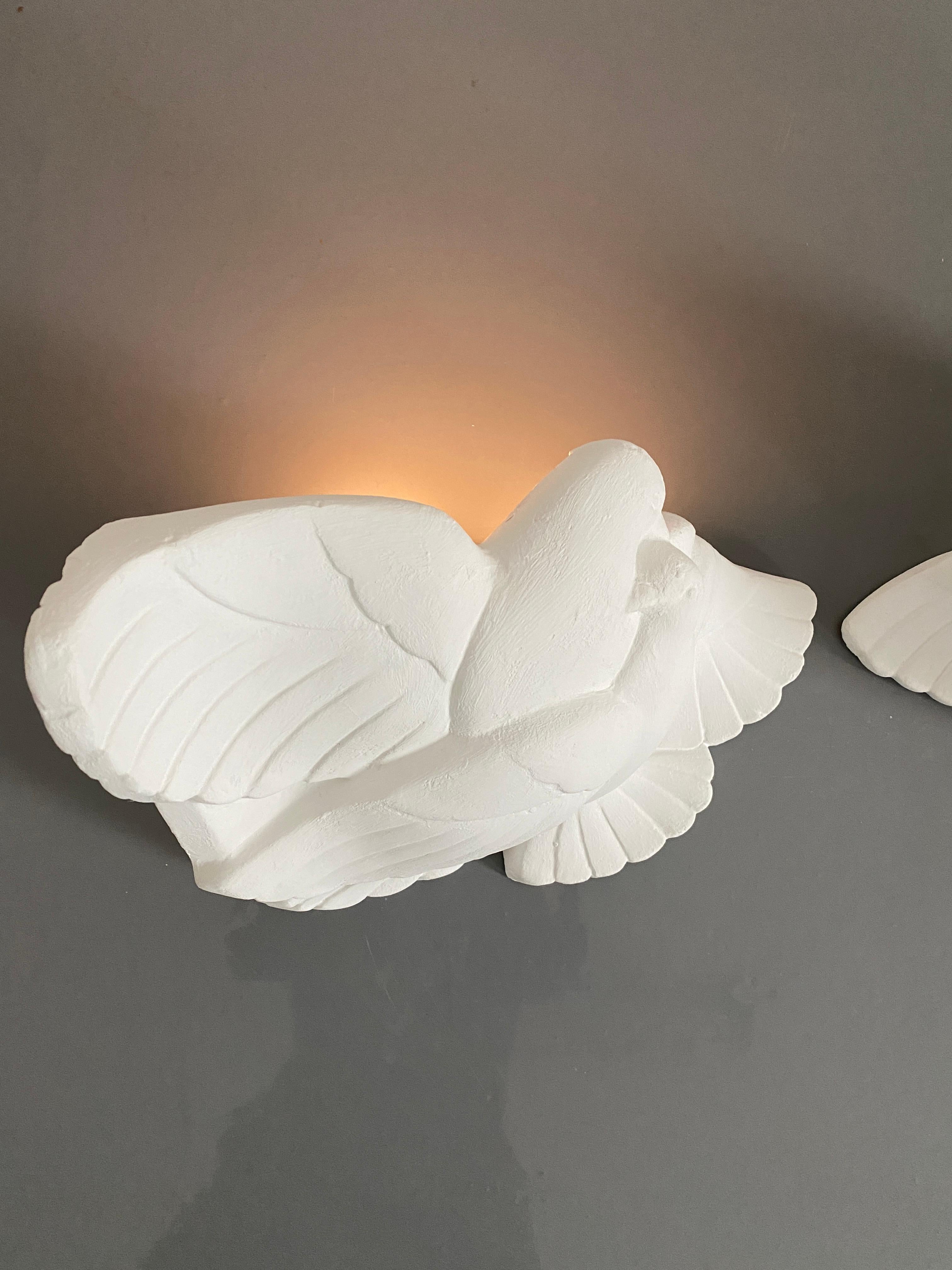 Pair of large Art Deco white plaster dove sconces to be placed in the corner of a room- sold as a pair

France, circa 1935 rare pair of plaster wall lamps depicting some love birds. Uplight with one e27 bulb. newly rewired with new sockets,