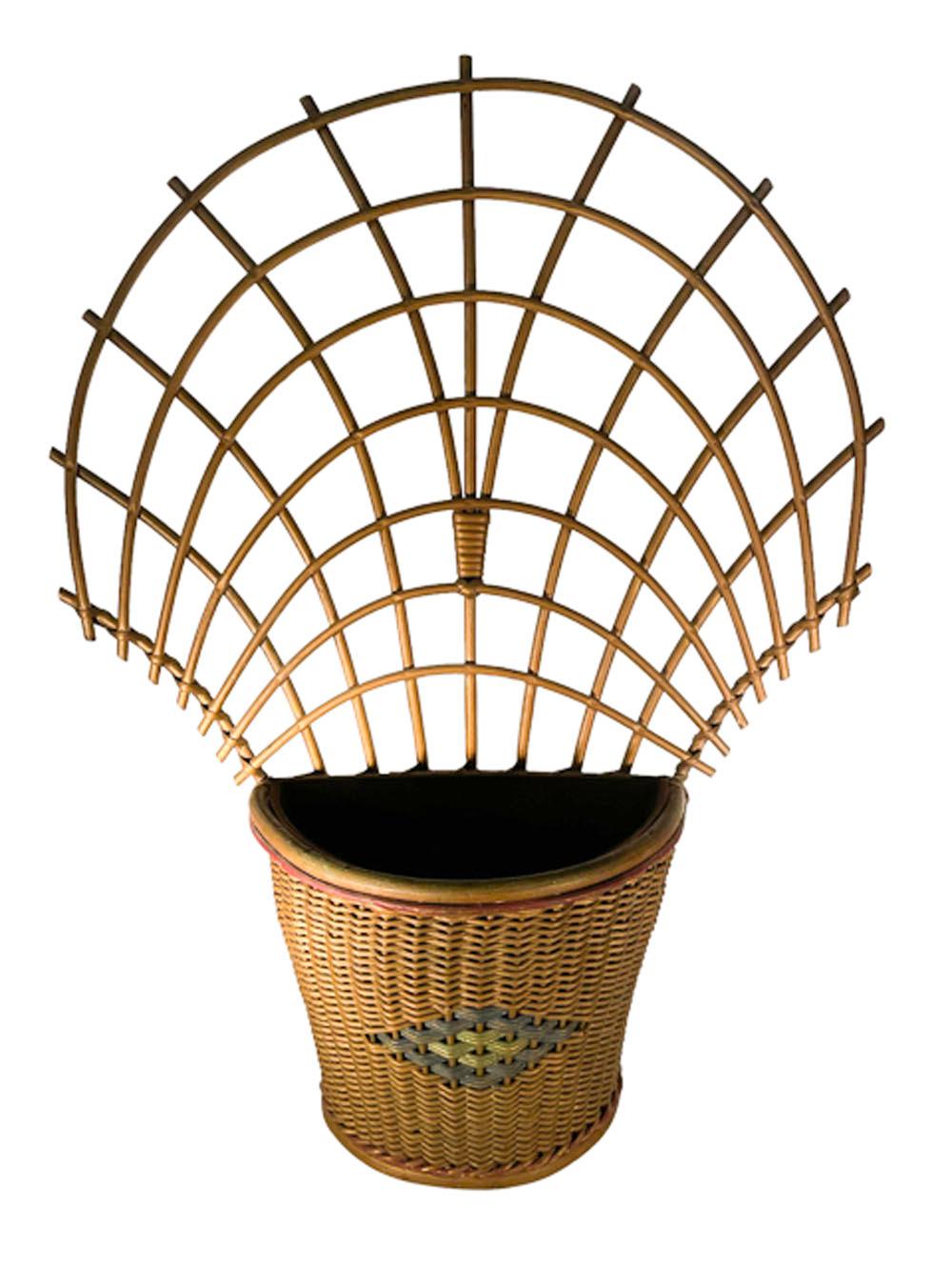 Pair of American Art Deco wicker wall-hung planters retaining their original bronze painted finish with red, blue and green accents. Half round tapered planters of tightly woven cane with a central stylized woven diamond painted blue and green and