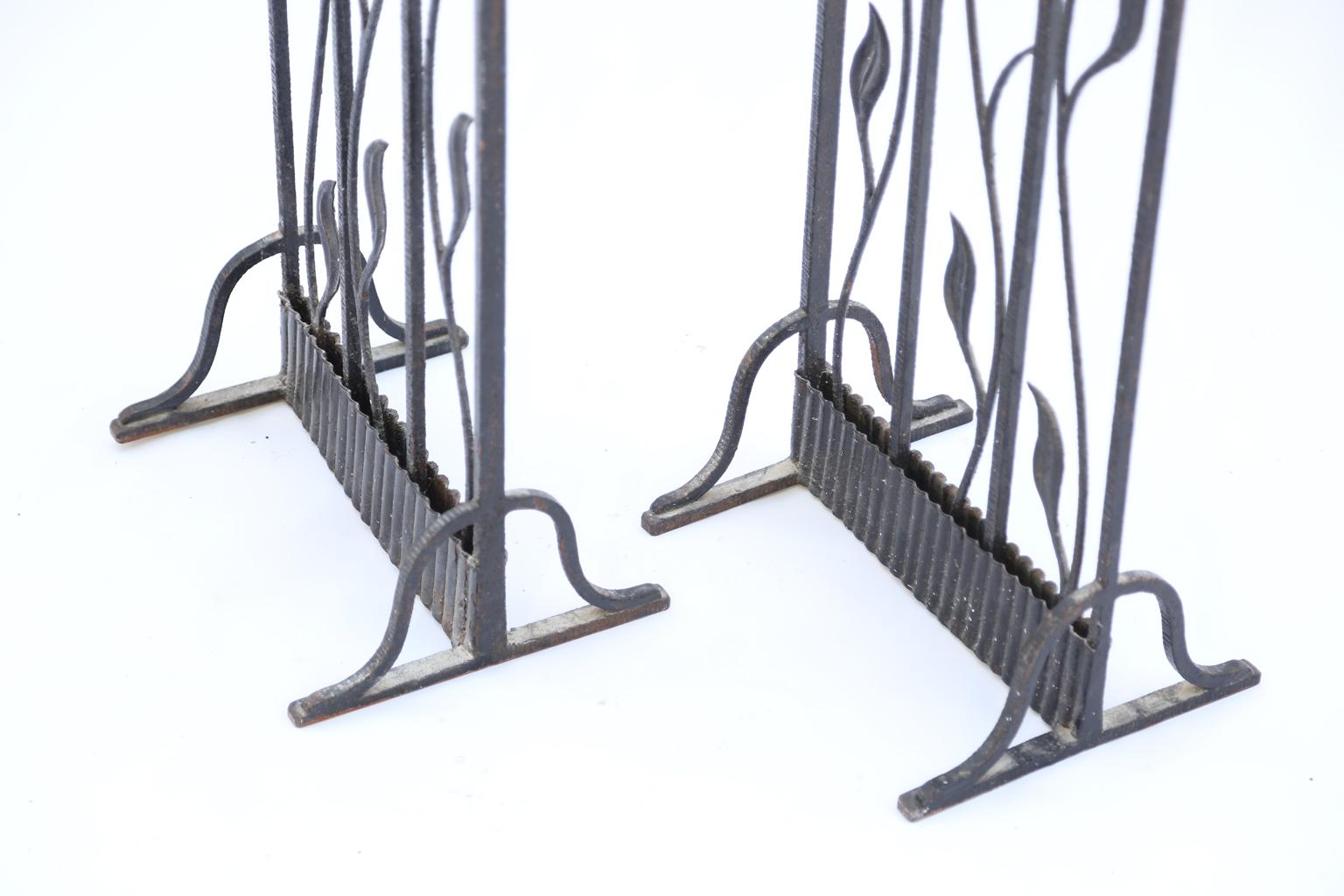Pair of Art Deco gates, now a screen or room divider, of wrought iron, each side having a scalloped arch, inset with scrolling foliate vines.

Stock id: D1841.