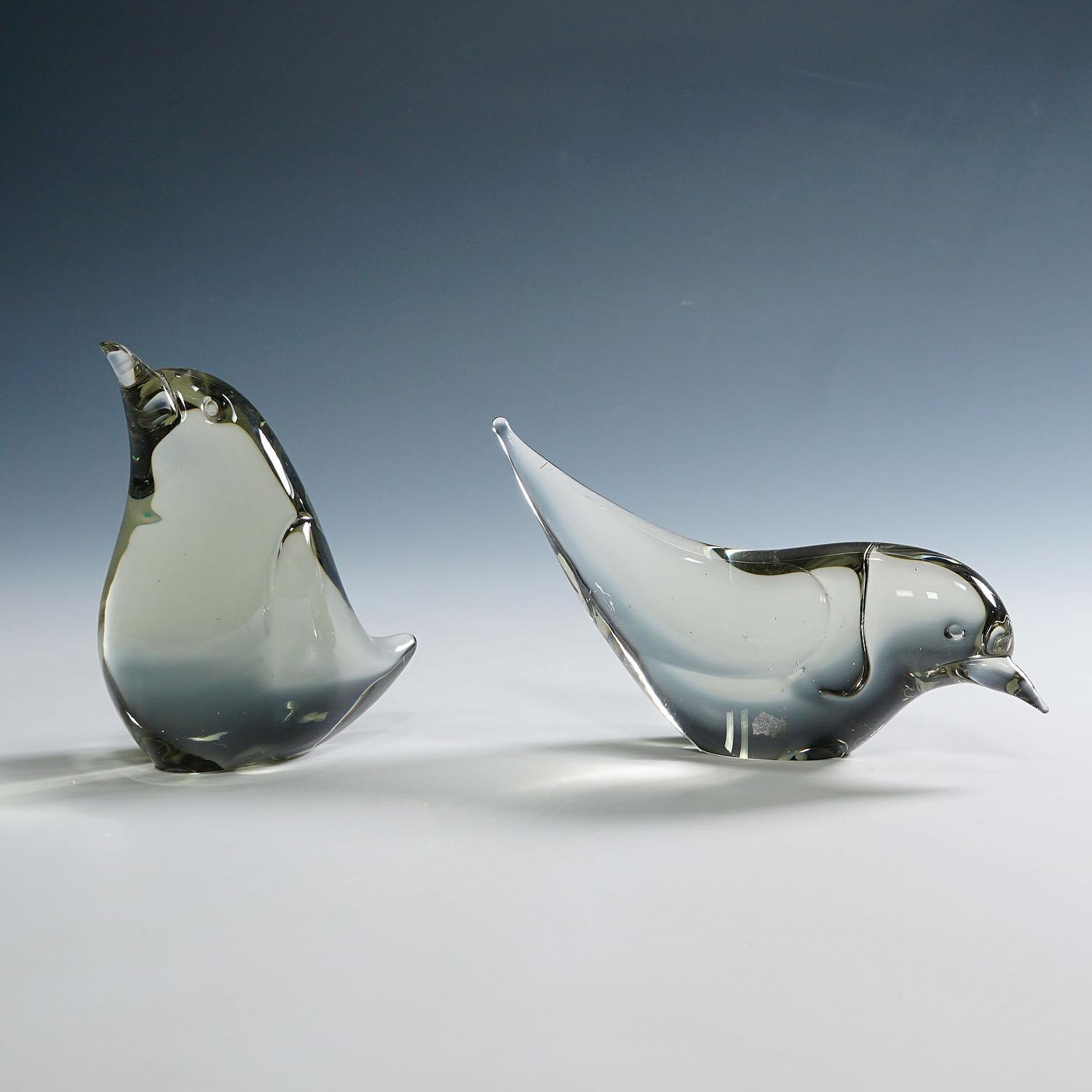 Pair of Art Glass Birds Designed by Livio Seguso ca. 1970s

A pair stylized art glass sculptures of little birds in smoke grey glass. They are hand made in the Graal glass manufactory, Germany. Designed by Livio Seguso ca. 1970. On the base one