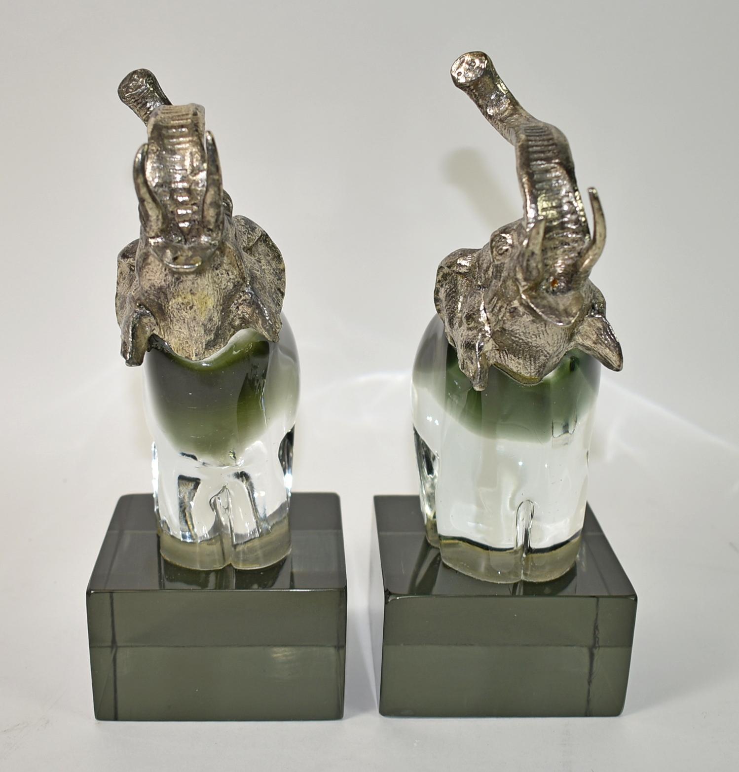 Pair of Art Glass Elephant Bookends. Metal heads and smoky and clear glass bases. Not signed but in the style of Murano. Excellent Vintage condition, no chips or cracks, very heavy, some wear to bottom consistent with usage and age. Dimensions: 9.5
