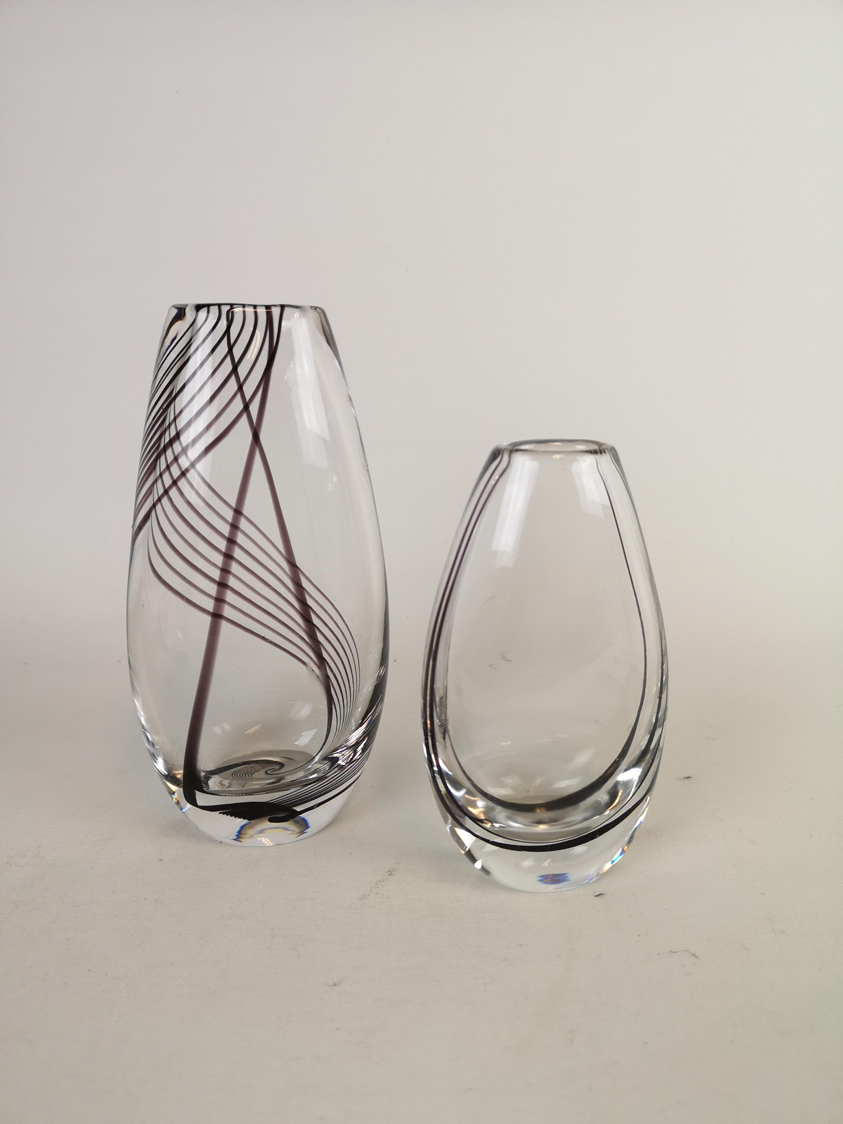 A pair of art glass vases designed by Vicke Lindstrand for Kosta Sweden. They both have swirl lines of purple and black inside of the glass. 

Nice condition with some scratch on the smaller one. 

Measures H 18 W 9 / H 14 W 8.
  