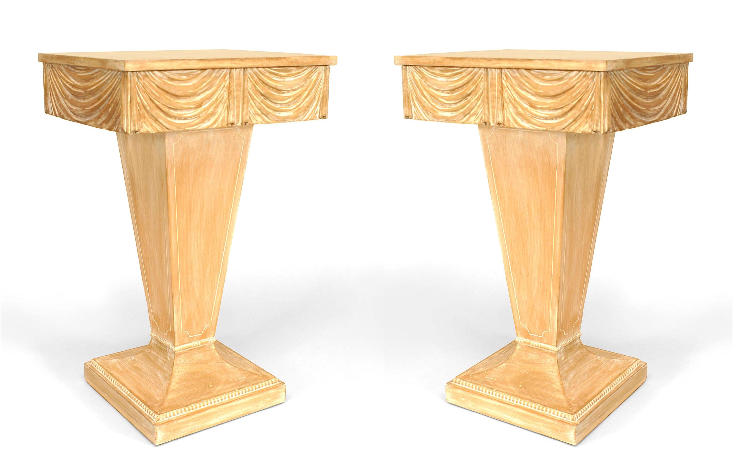 Pair of Art Moderne stripped end tables with a carved swag apron and drawer supported on a tapered pedestal base. (GROSFELD HOUSE) (PRICED AS Pair)
