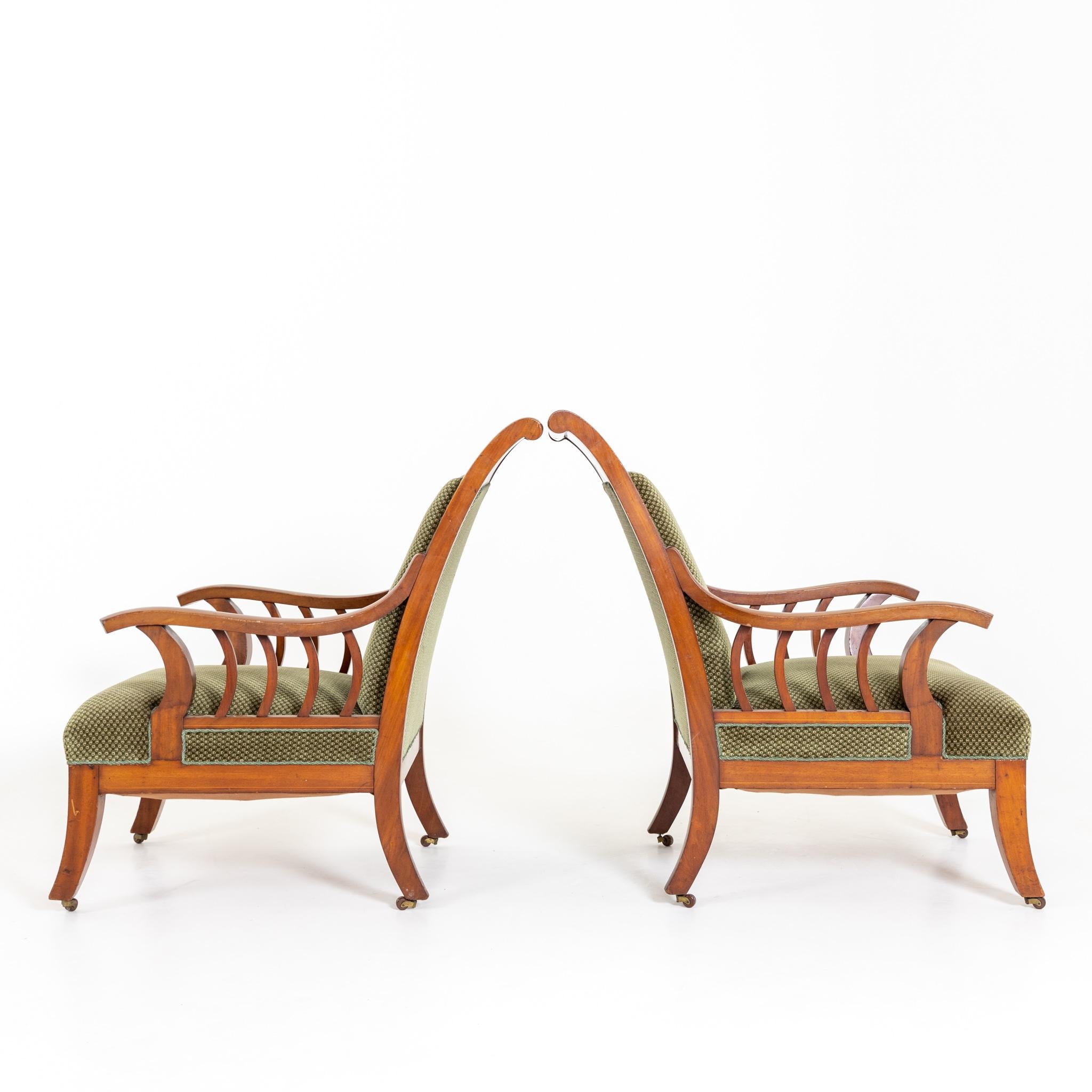 Pair of Scandinavian armchairs with sled shaped backs and elegantly curved armrests with thread inlays. Unrestored condition.