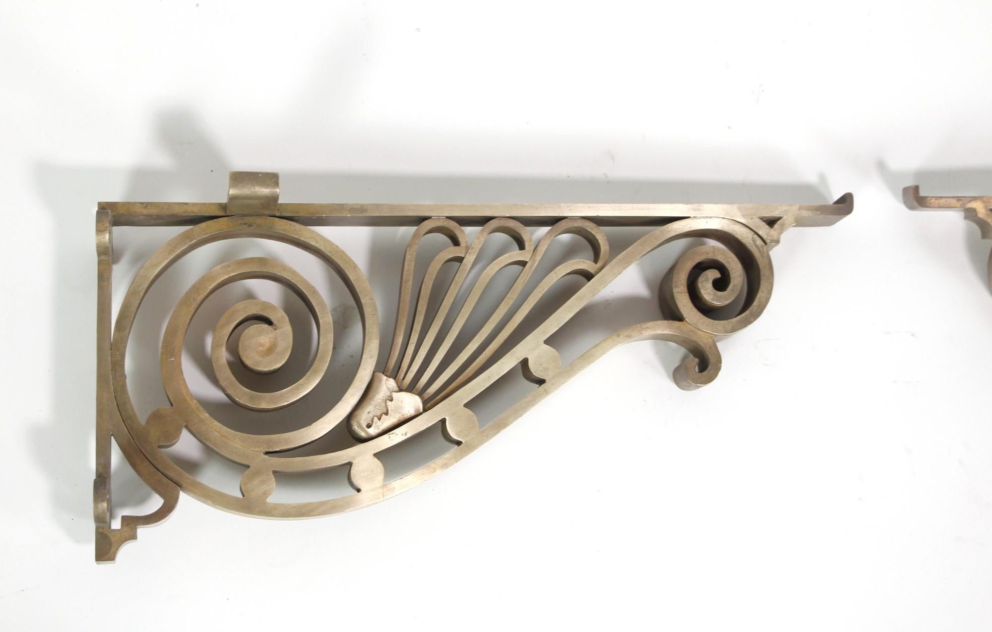 Early 20th Century Art Nouveau cast bronze brackets featuring a polished finish. Spiral design enhancement the beauty and strength of these antique brackets. Priced as a pair. Please note, this item is located in one of our NYC locations.