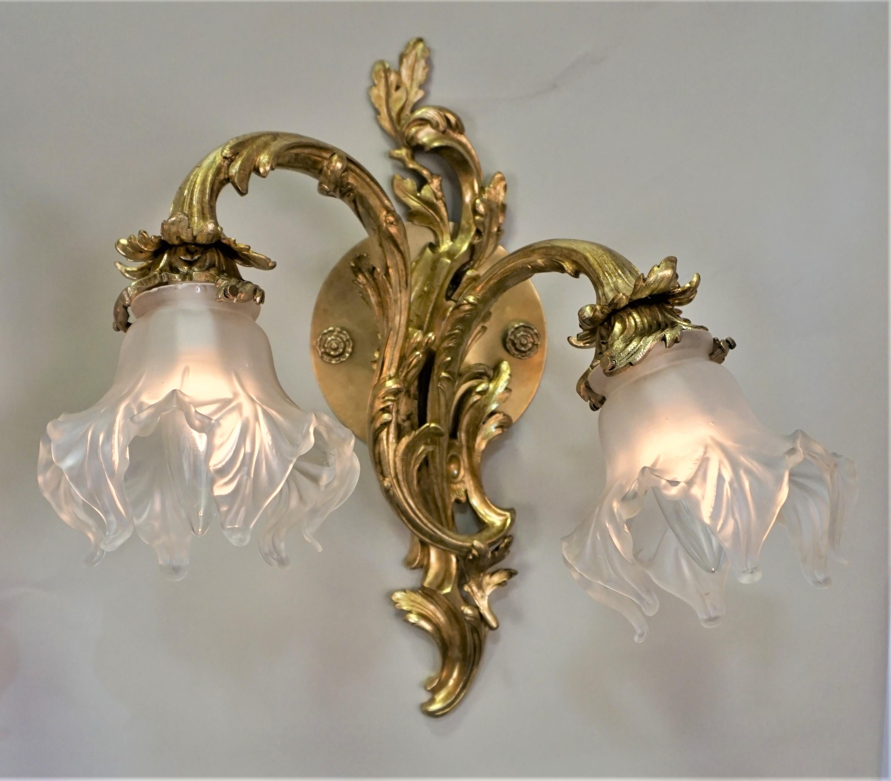 Pair of French Art Nouveau glass wall sconces with clear frost blown glass shades.
