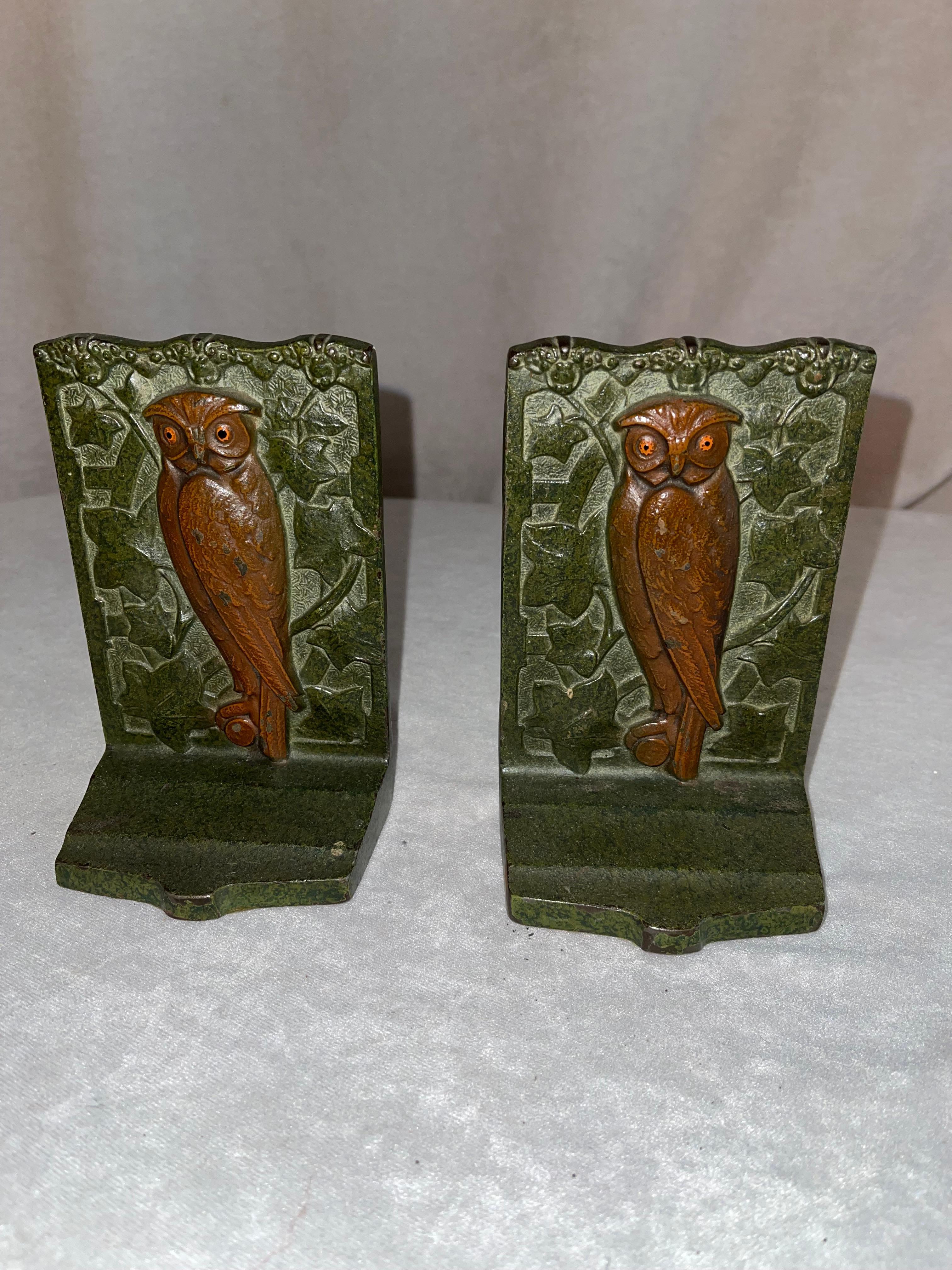 These bookends are top of the line work by Judd Co. The detailing is exceptional, and the green patina helps show off that work. The art nouveau flowing leaves really enhances the look. 
 These are really exceptional and the only real wear is on