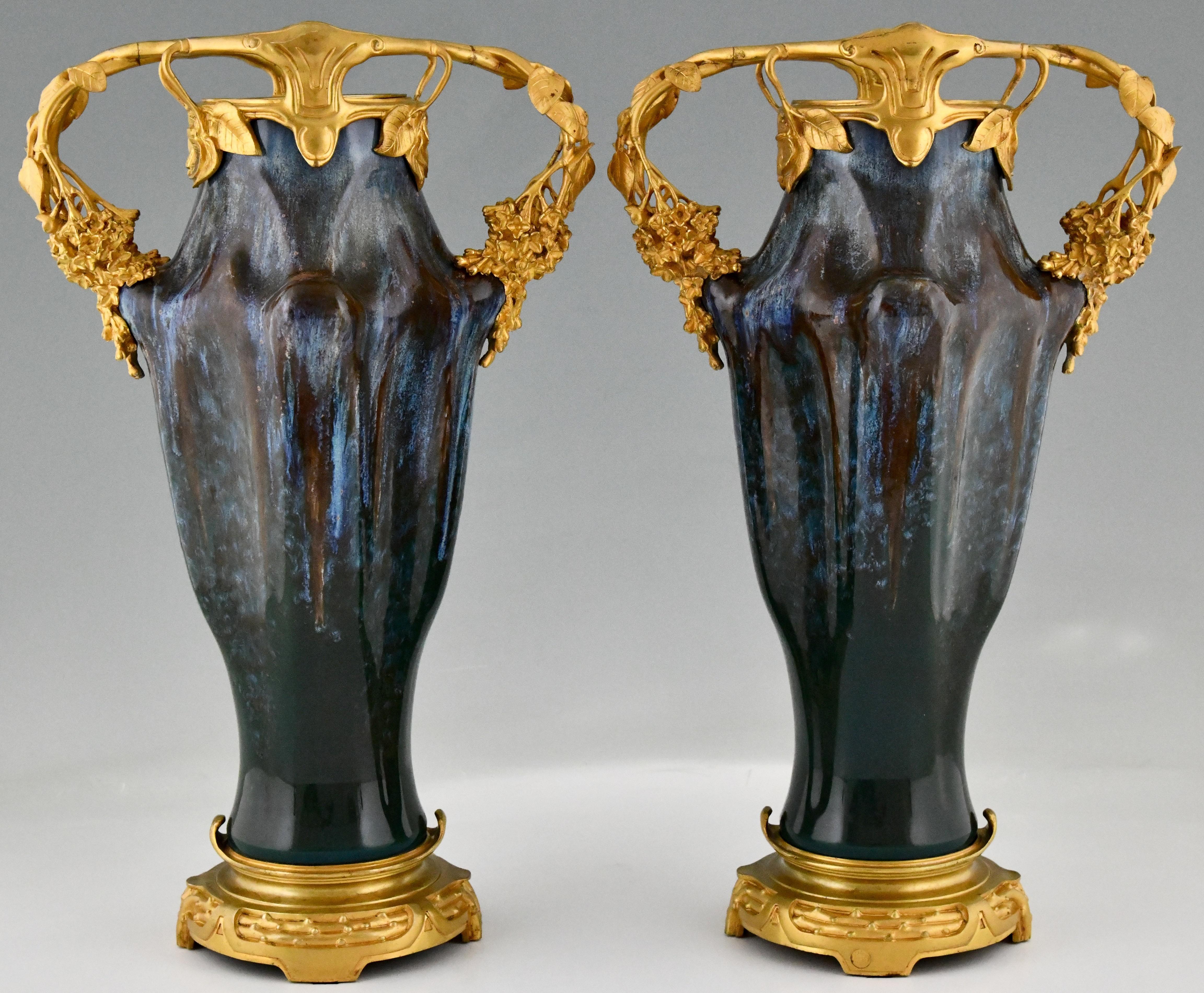 Pair of Art Nouveau ceramic and bronze vases by Paul Louchet (1854-1936).
Alphonse Lamarre & Manufacture Pillivuyt. 
Ceramic with blue and grey enamel. 
Gilt bronze. 
France 1900.