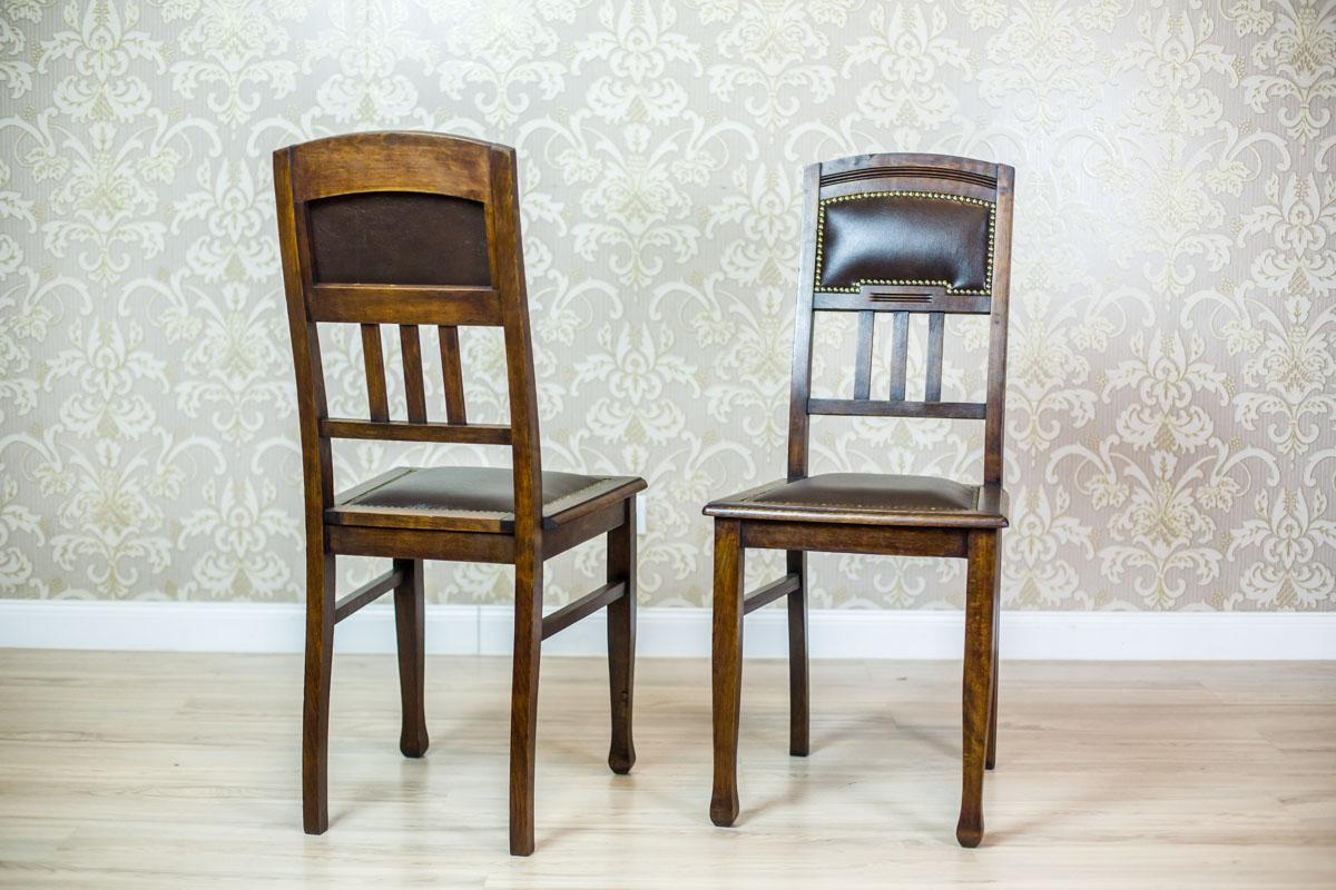 We present you two chairs made of oak wood, circa first quarter of the 20th century.
The seat and the upper section of the backrest are padded with leather, which is fixed with a molding made of brass studs.
These chairs are in the Art Nouveau