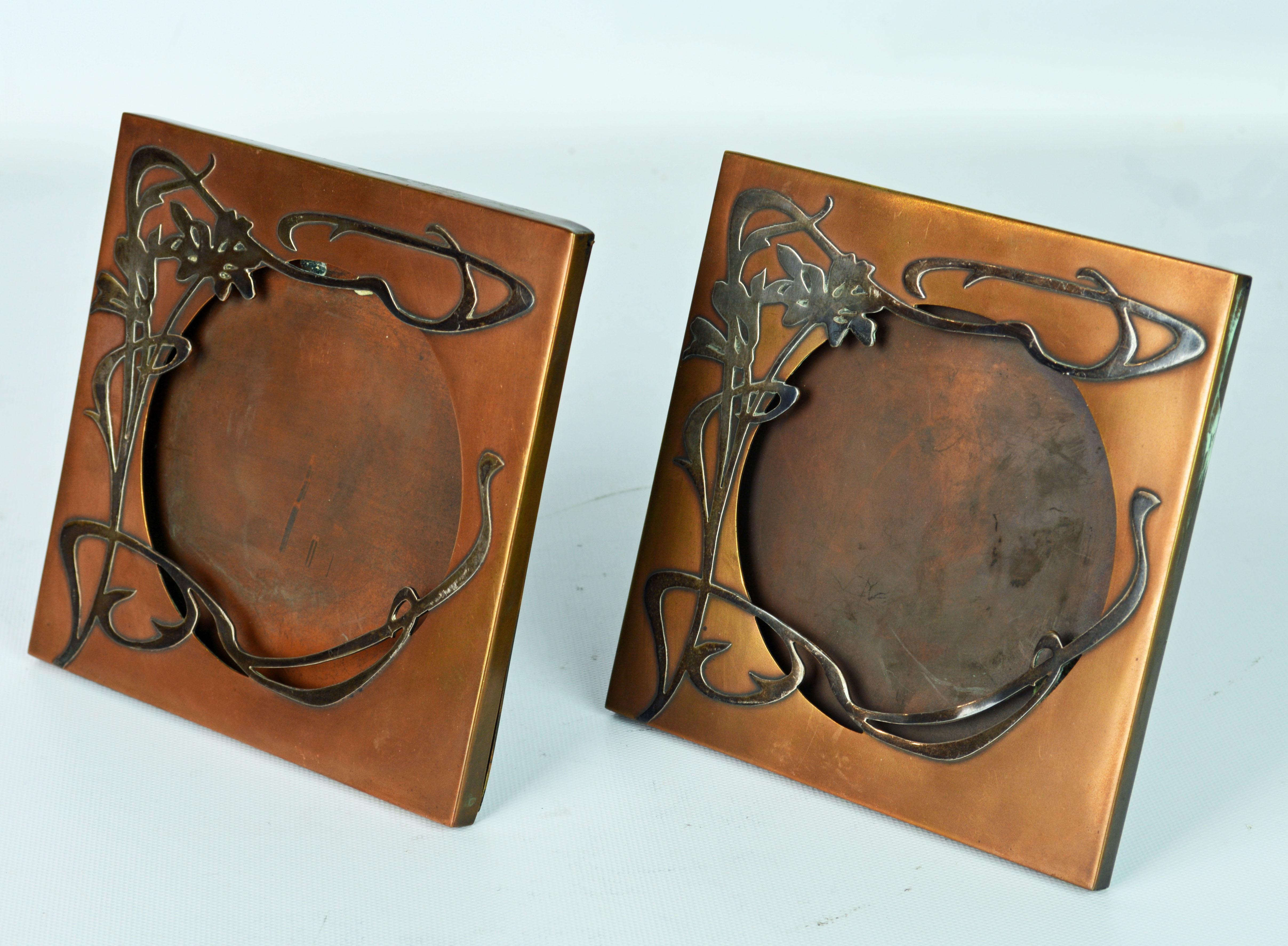 Dating to the early 20th century these exceptional art nouveau photo frames feature beautifully crafted sterling silver overlay on a patinated bronze background. Both frames are branded on the back with the Heintz logo mark.
