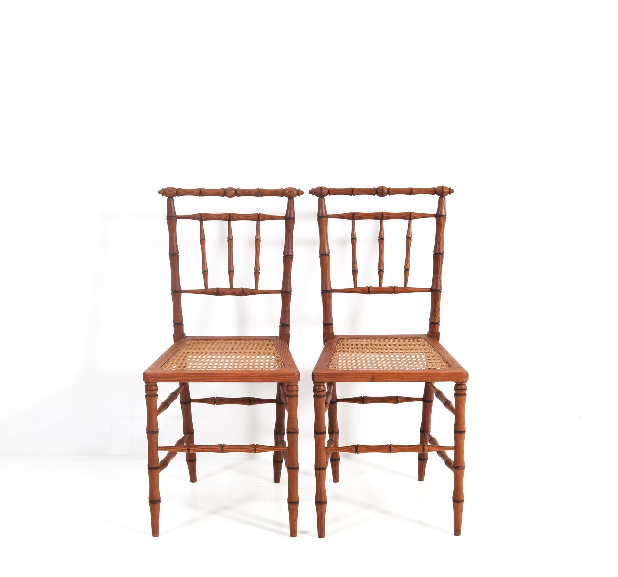 Magnificent and rare pair of Art Nouveau side chairs.
Striking French design from the 1900s.
Solid pitch-pine frames in the Faux Bamboo style with original.
Wicker seats.
Rare because of the fact that this wonderful pair of Faux Bamboo side